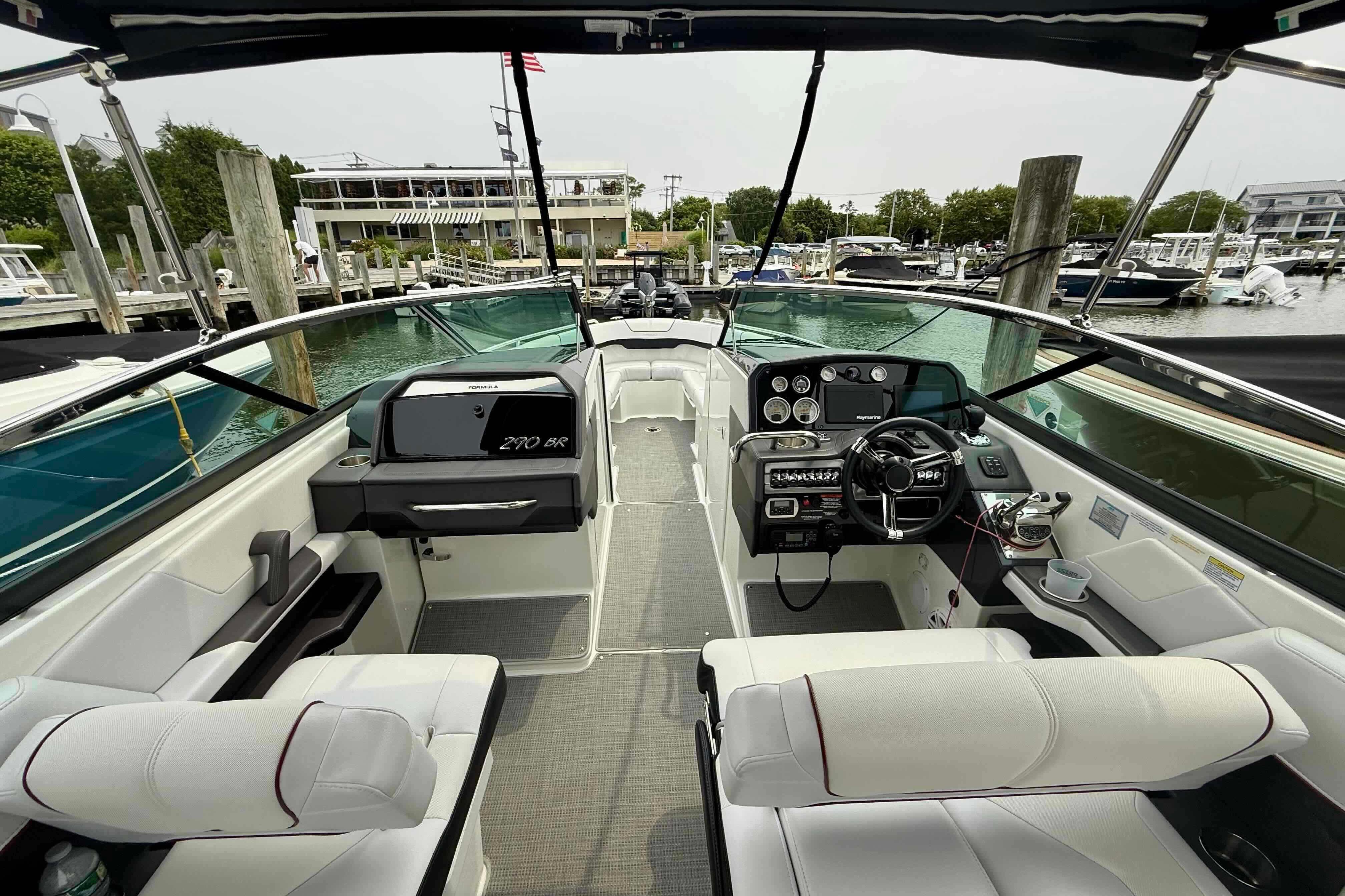 2020 Formula 290 Bowrider interior, featuring sleek design and modern controls at a marina.