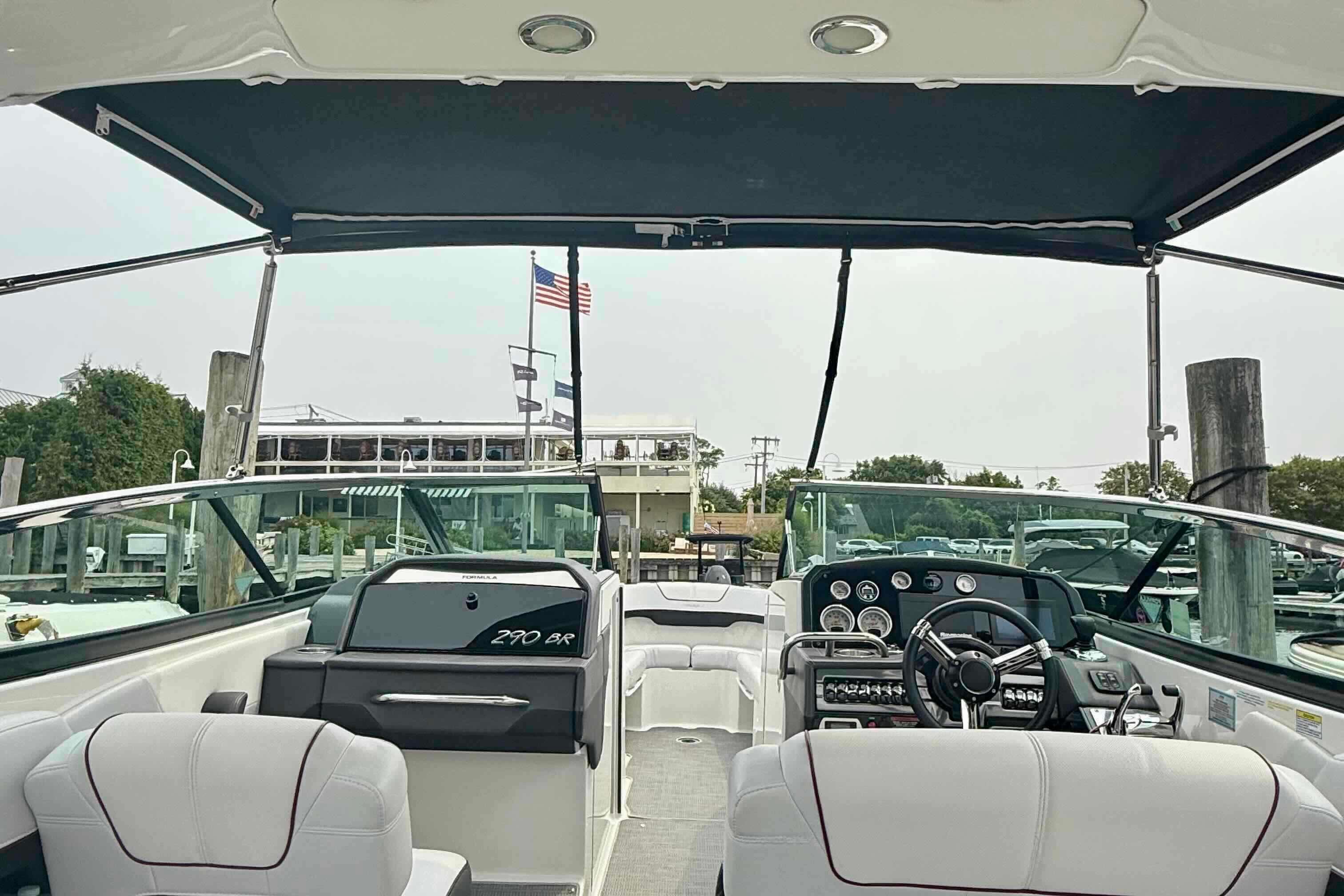 2020 Formula 290 Bowrider interior with steering wheel and seating, docked at marina.