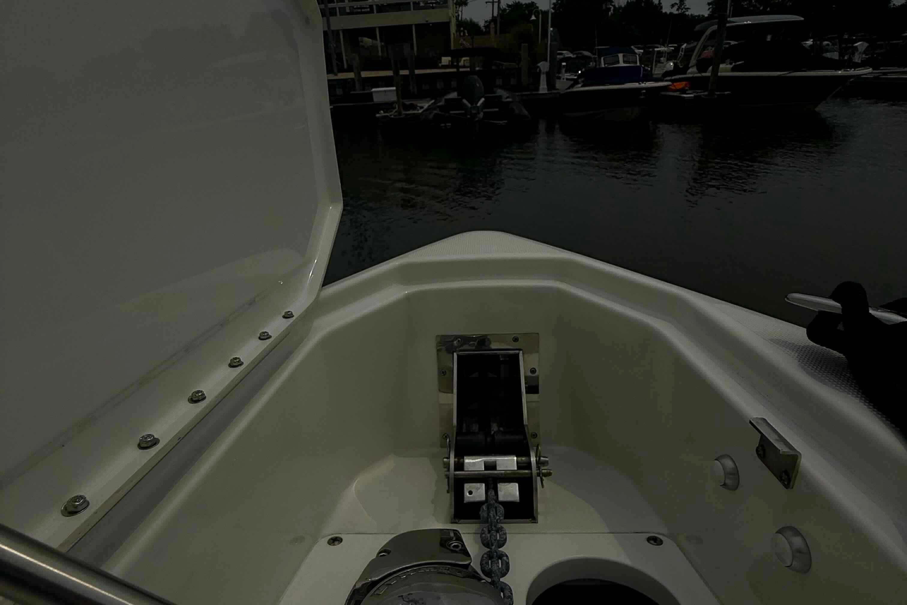 2020 Formula 290 Bowrider anchor compartment at marina, showcasing open hatch and chain.
