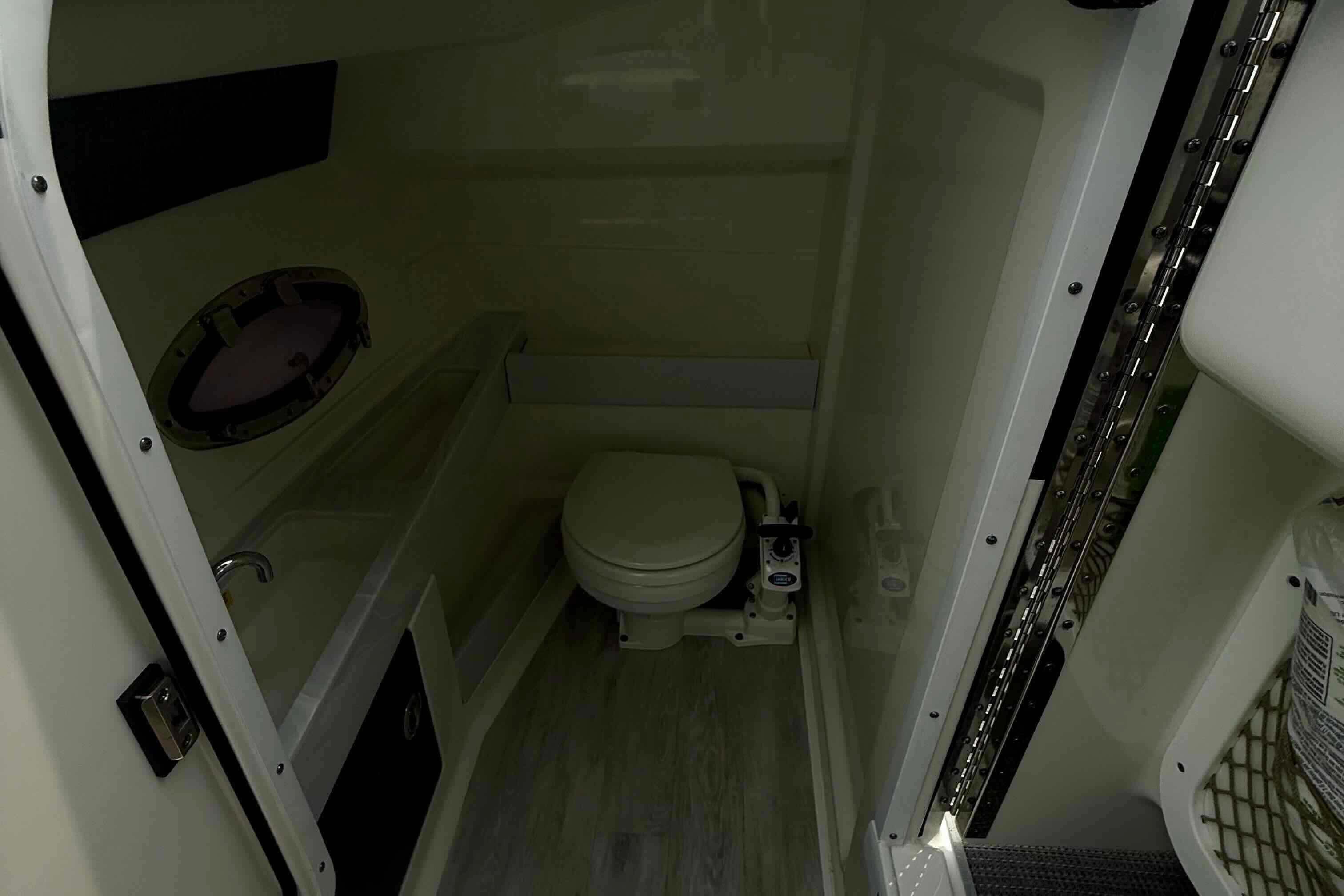 Interior of 2020 Formula 290 Bowrider boat bathroom with toilet and sink.