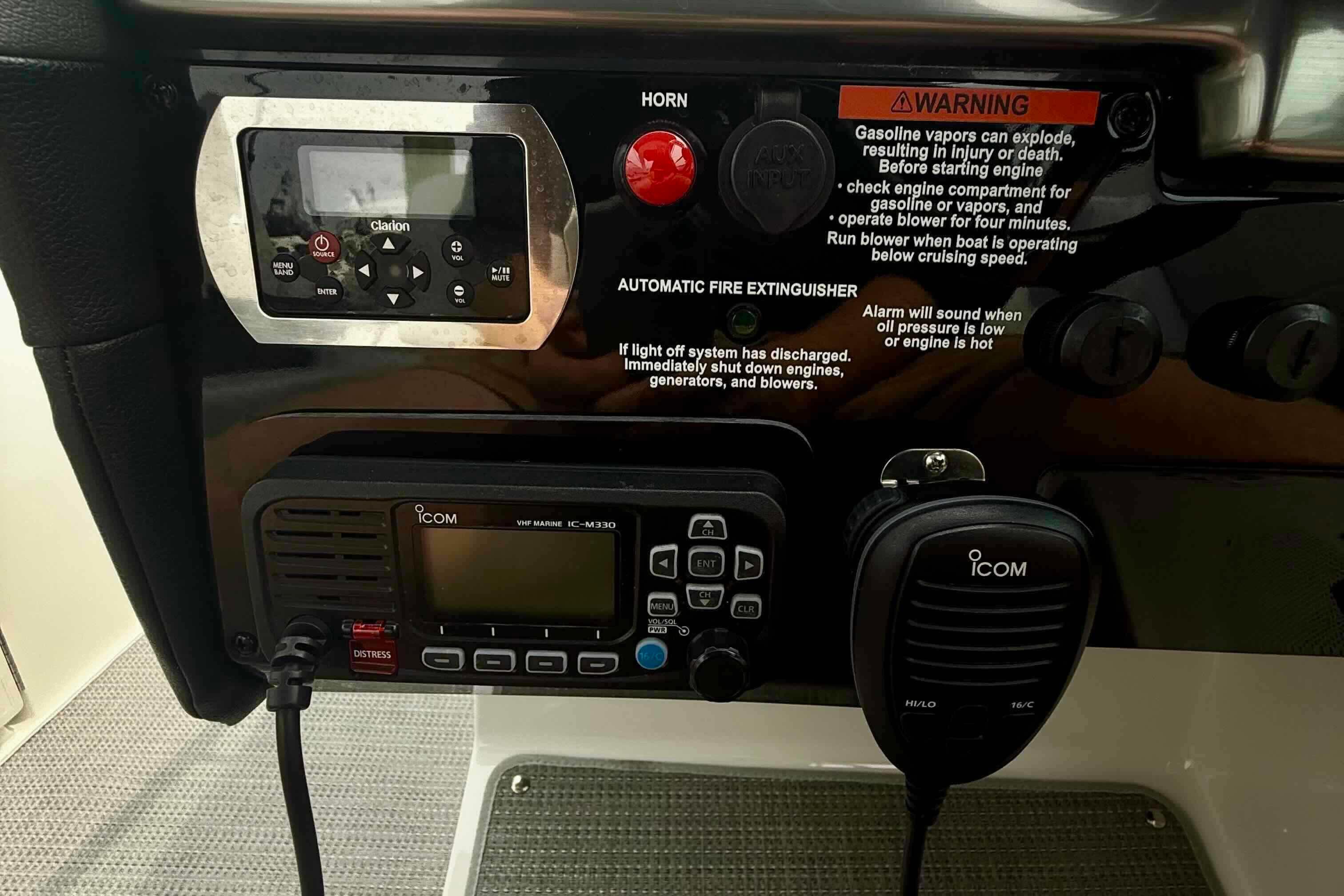 Control panel of a 2020 Formula 290 Bowrider with Icom VHF radio and warning labels.
