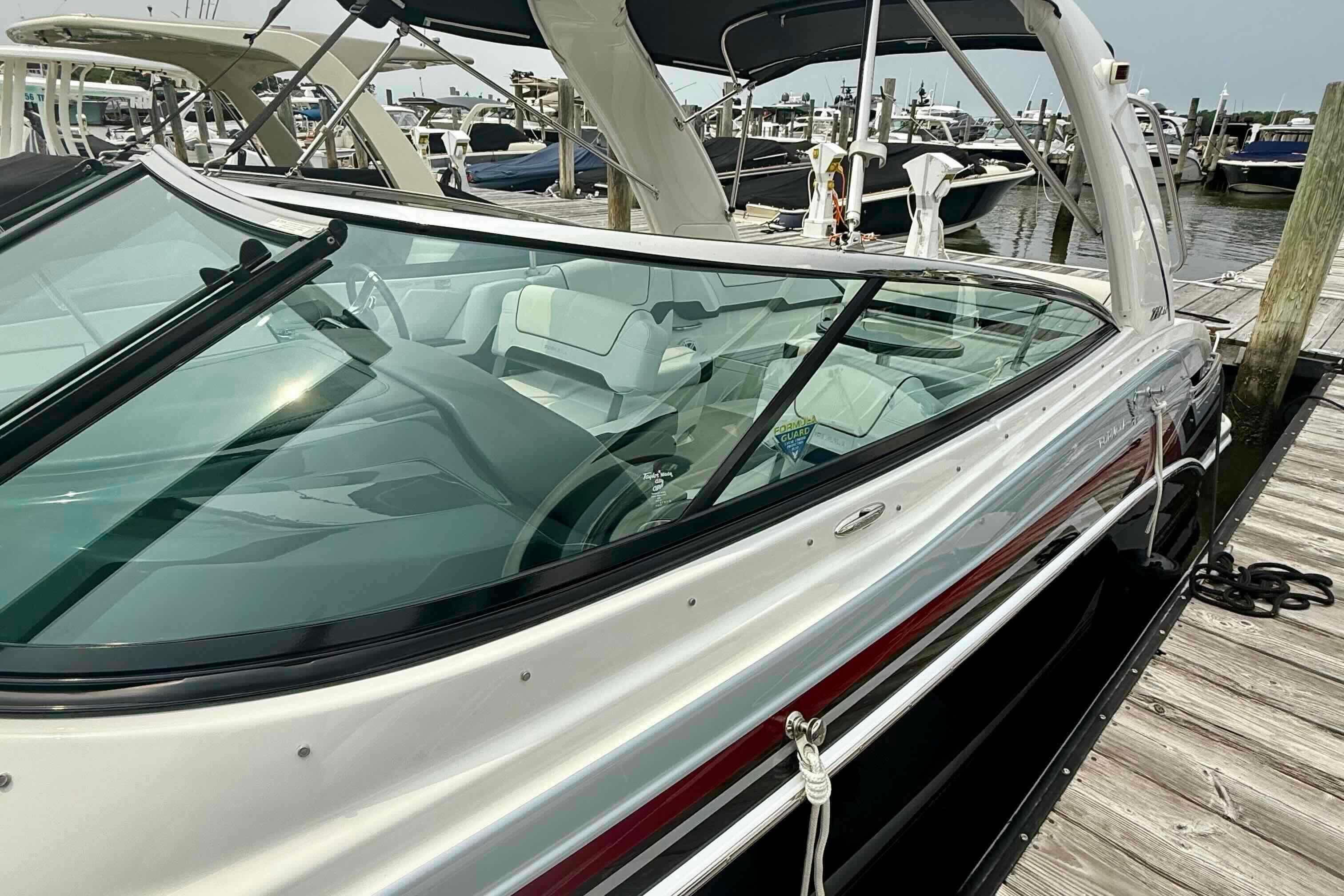 2020 Formula 290 Bowrider docked at marina, showcasing sleek design and spacious interior.