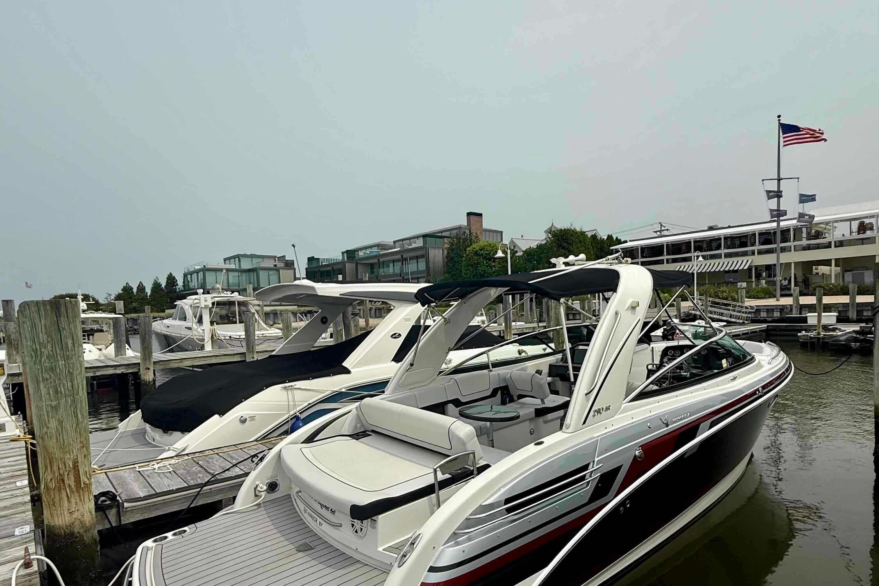 2020 Formula 290 Bowrider docked at marina with American flag in background.
