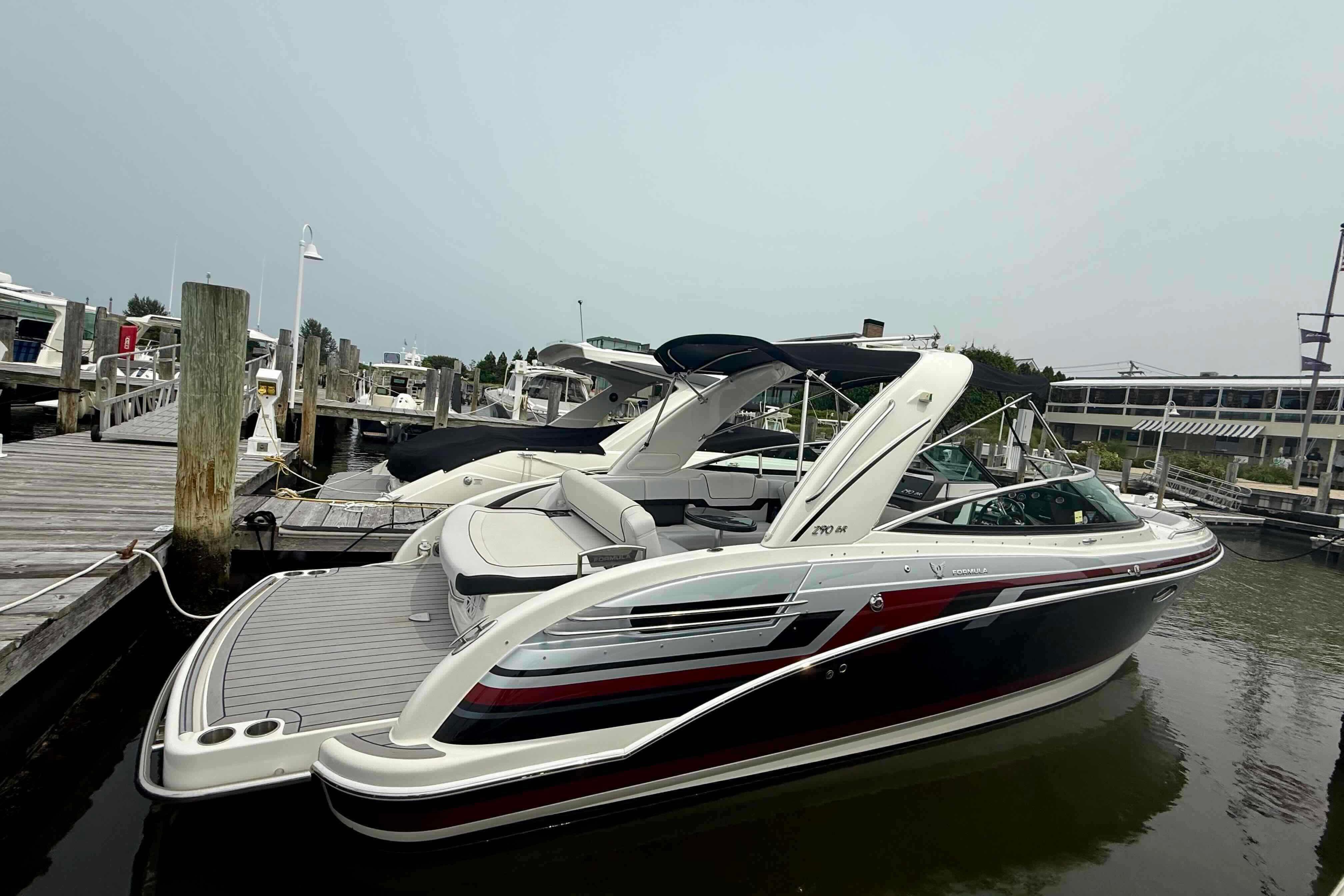 2020 Formula 290 Bowrider docked at marina, showcasing sleek design and spacious seating.