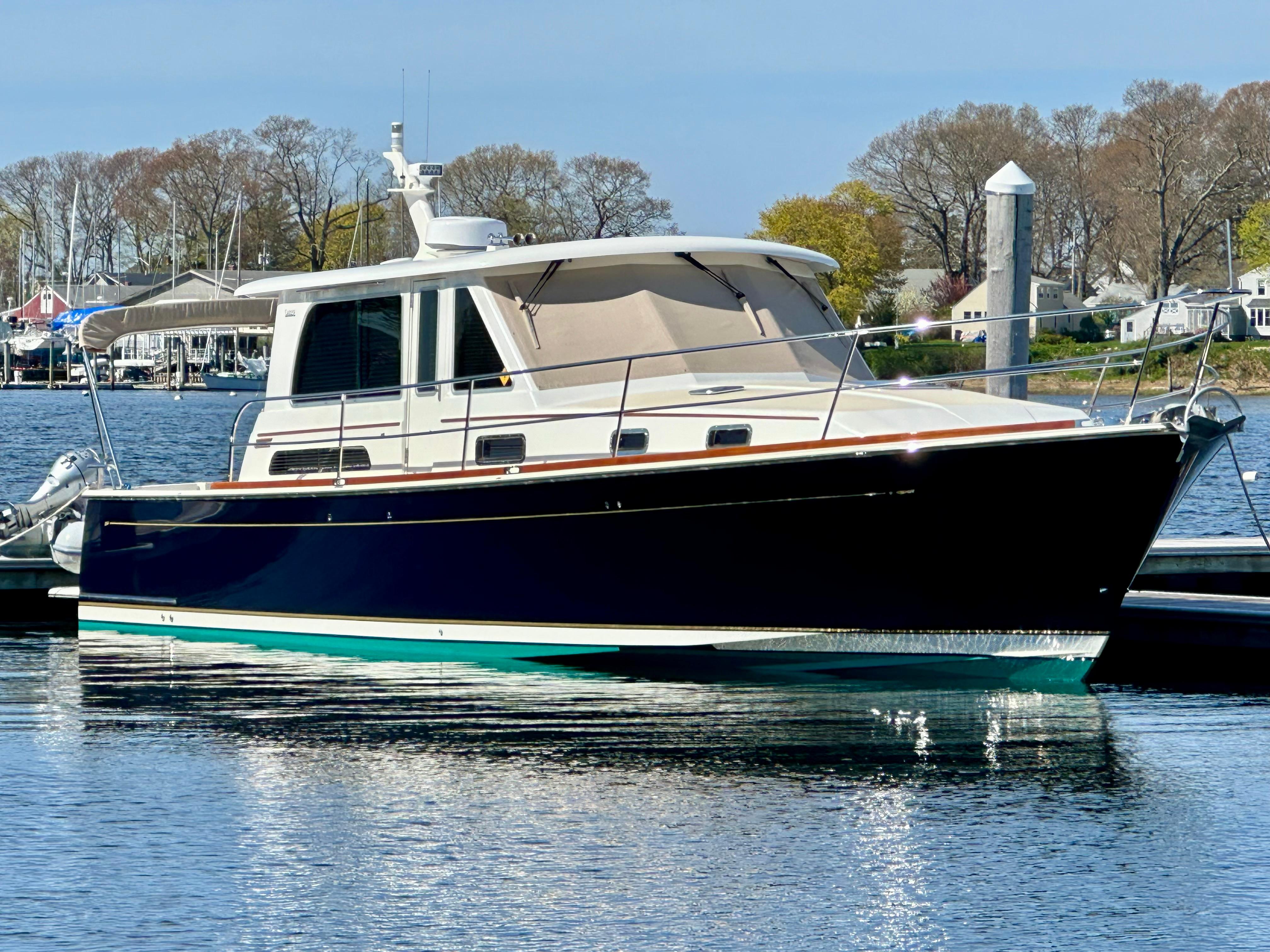 2017 Sabre 42 Salon Express yacht docked in a serene marina setting.
