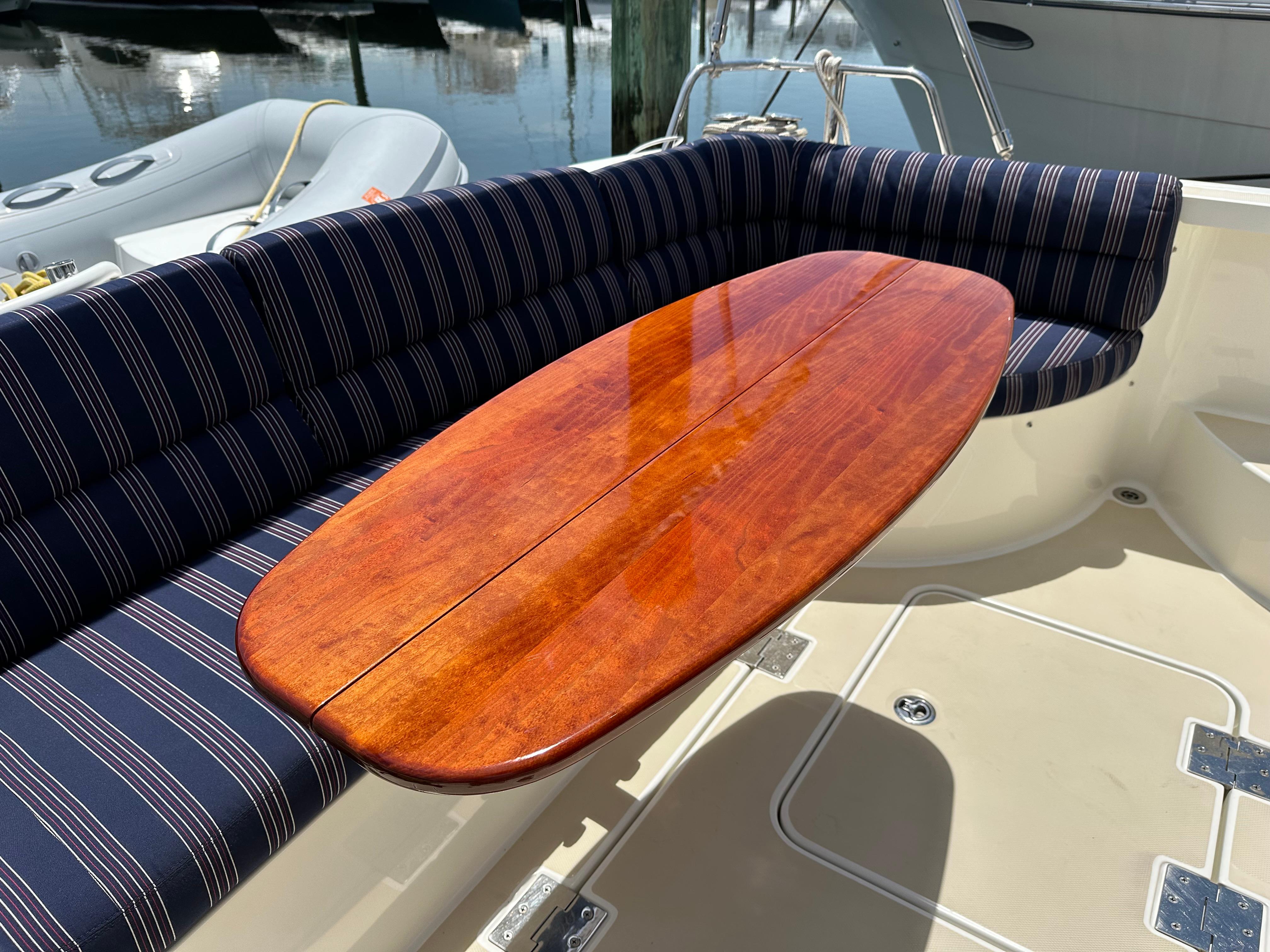 2017 Sabre 42 Salon Express yacht with striped seating and polished wooden table.