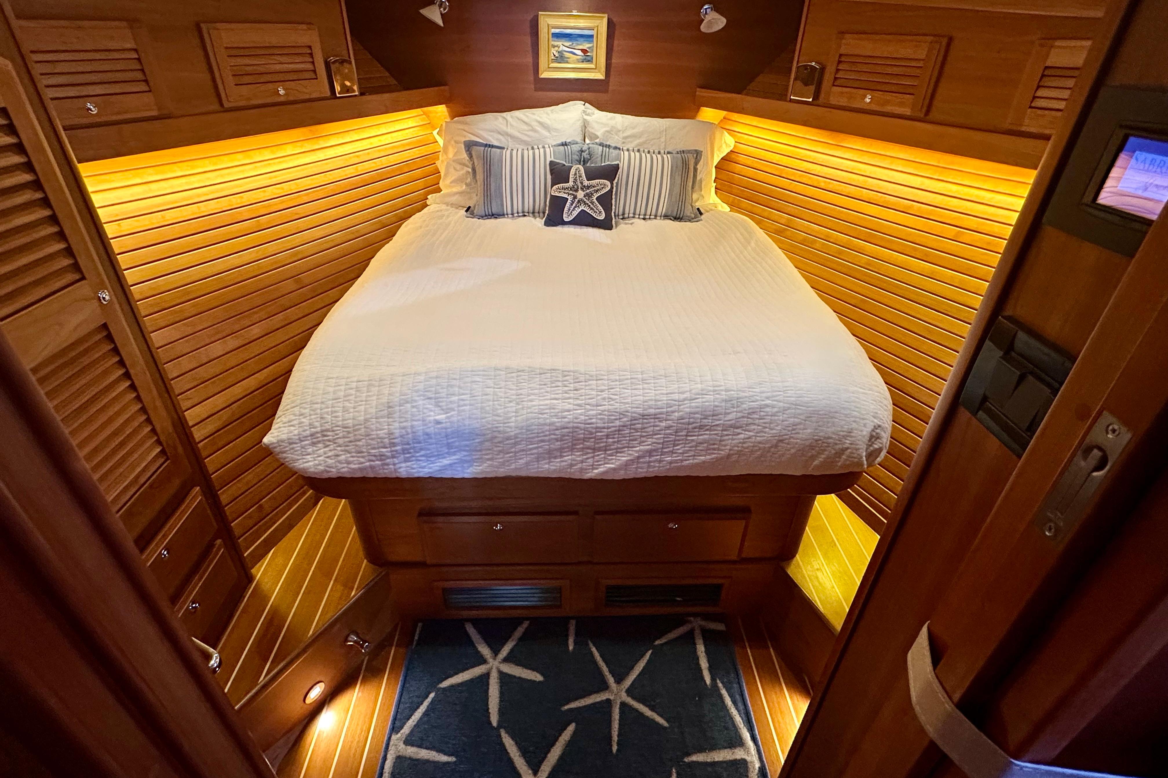 Cozy cabin interior of 2017 Sabre 42 Salon Express with warm lighting and nautical decor.