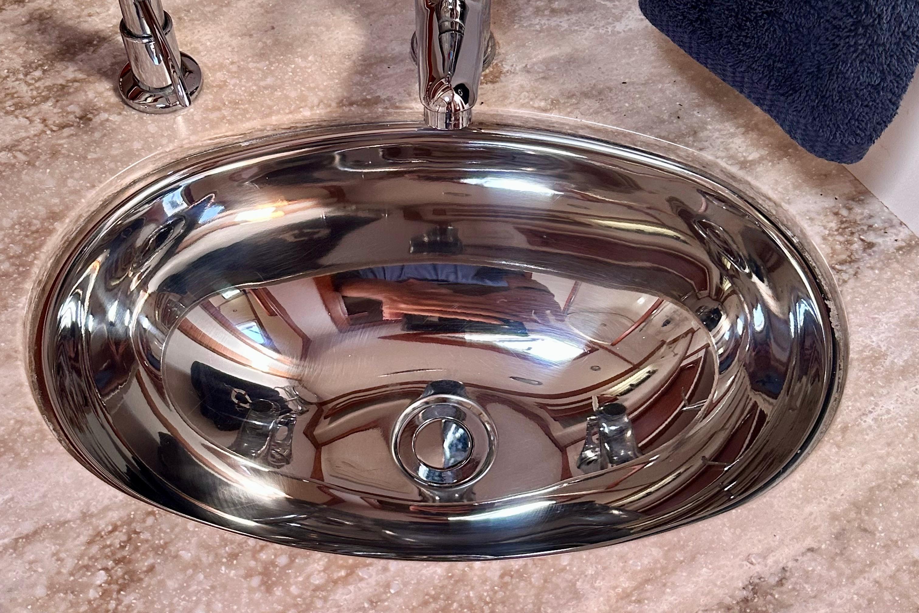 Stainless steel sink on Sabre 42 Salon Express 2017 yacht, reflecting interior details.