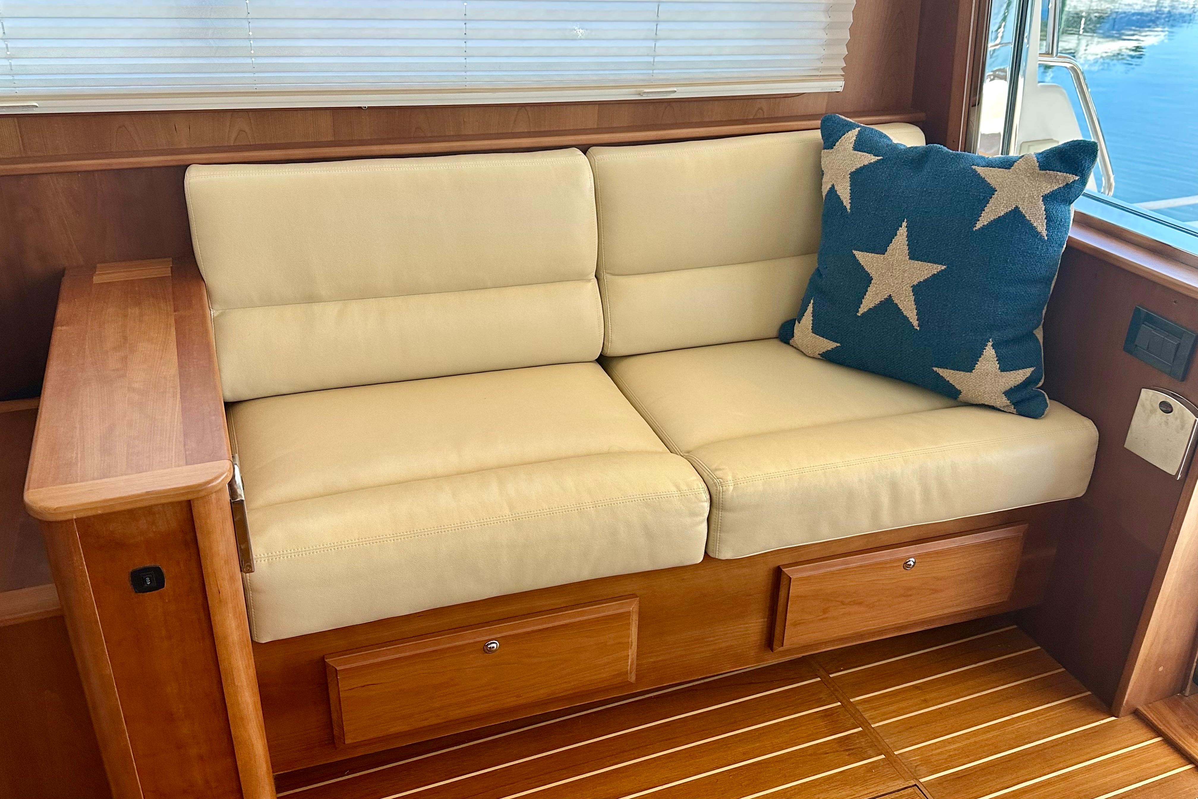 Interior of 2017 Sabre 42 Salon Express with beige sofa and star-patterned pillow.