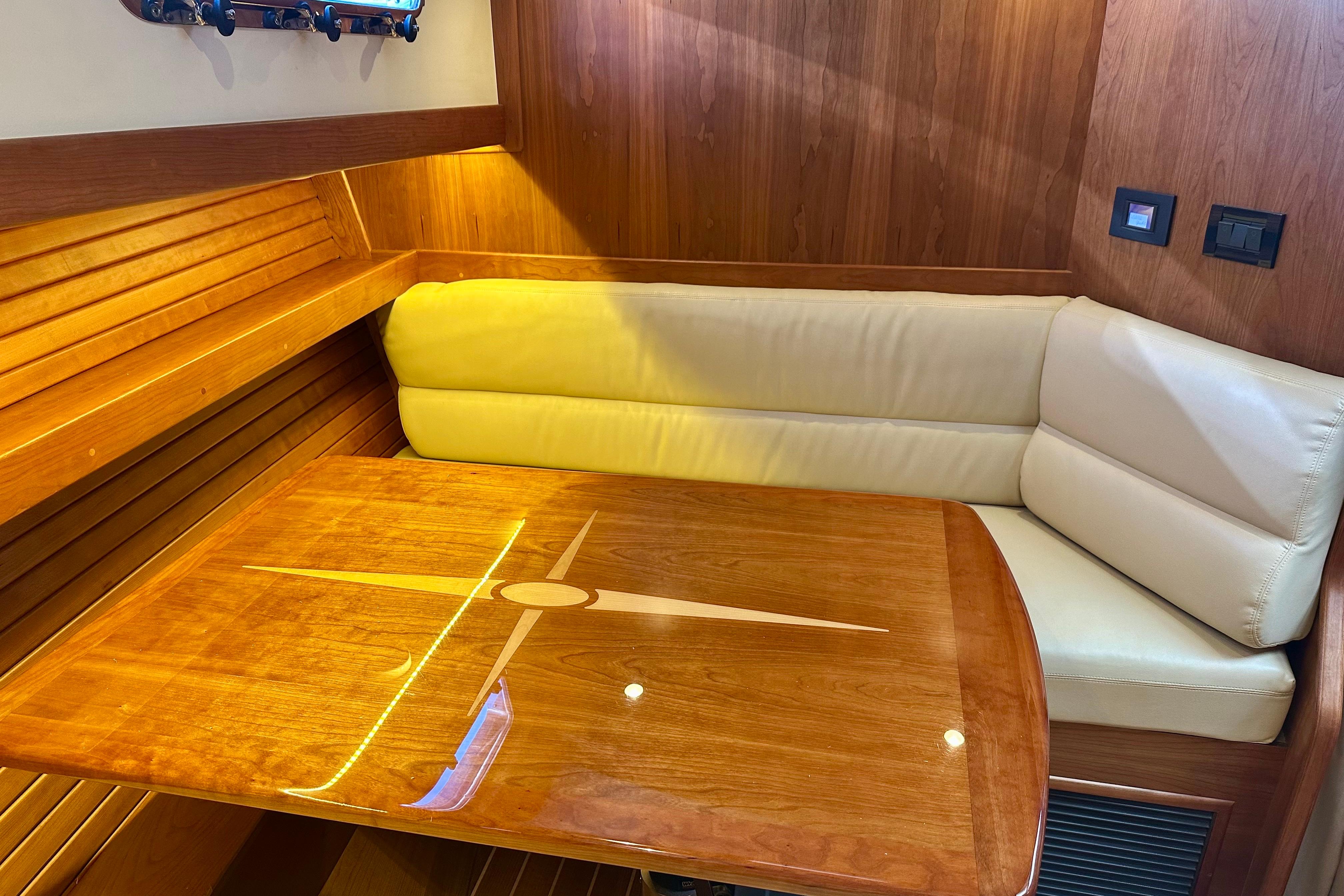 Luxurious interior of 2017 Sabre 42 Salon Express with wooden table and cream seating.
