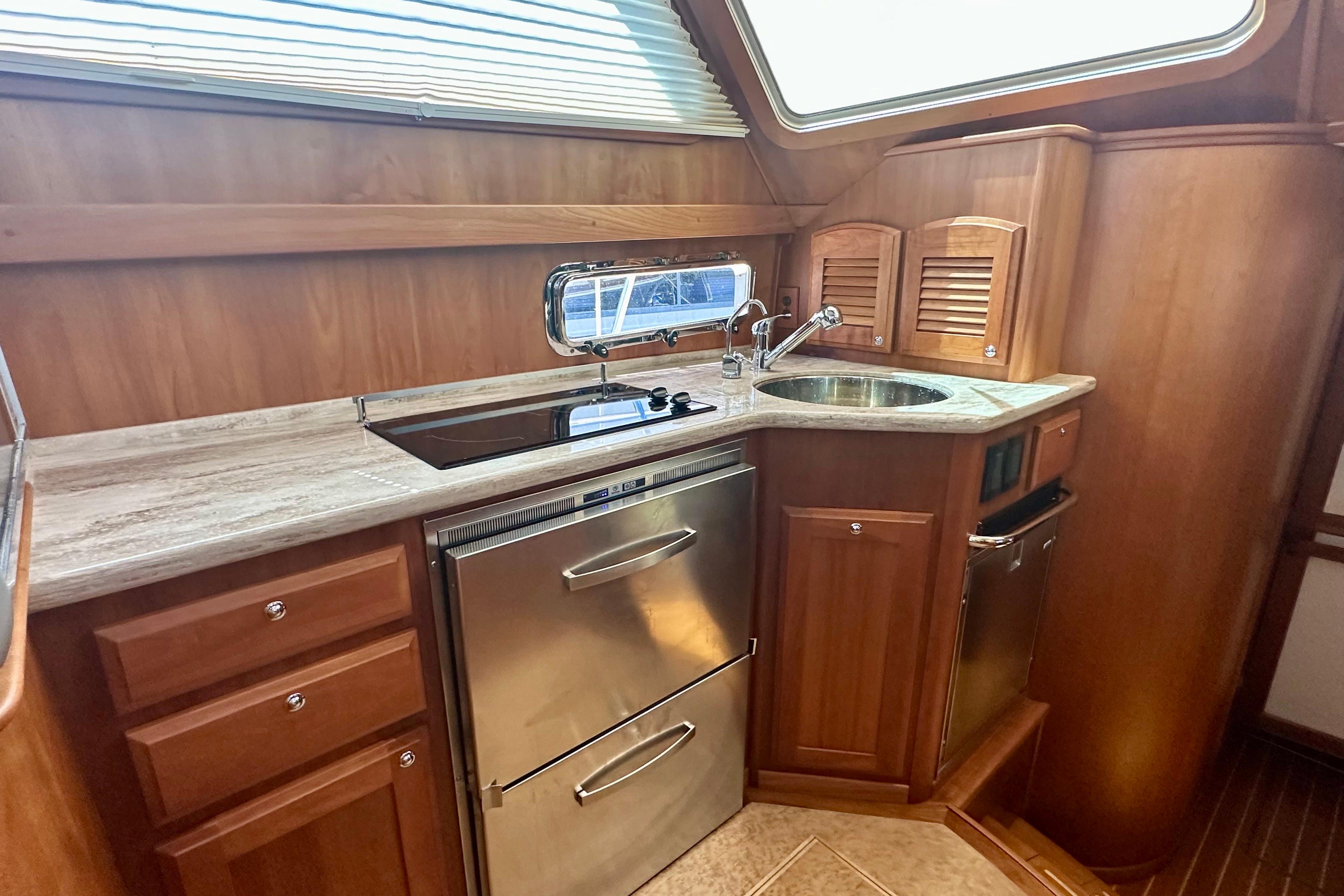 2017 Sabre 42 Salon Express galley with wood cabinetry and modern appliances.