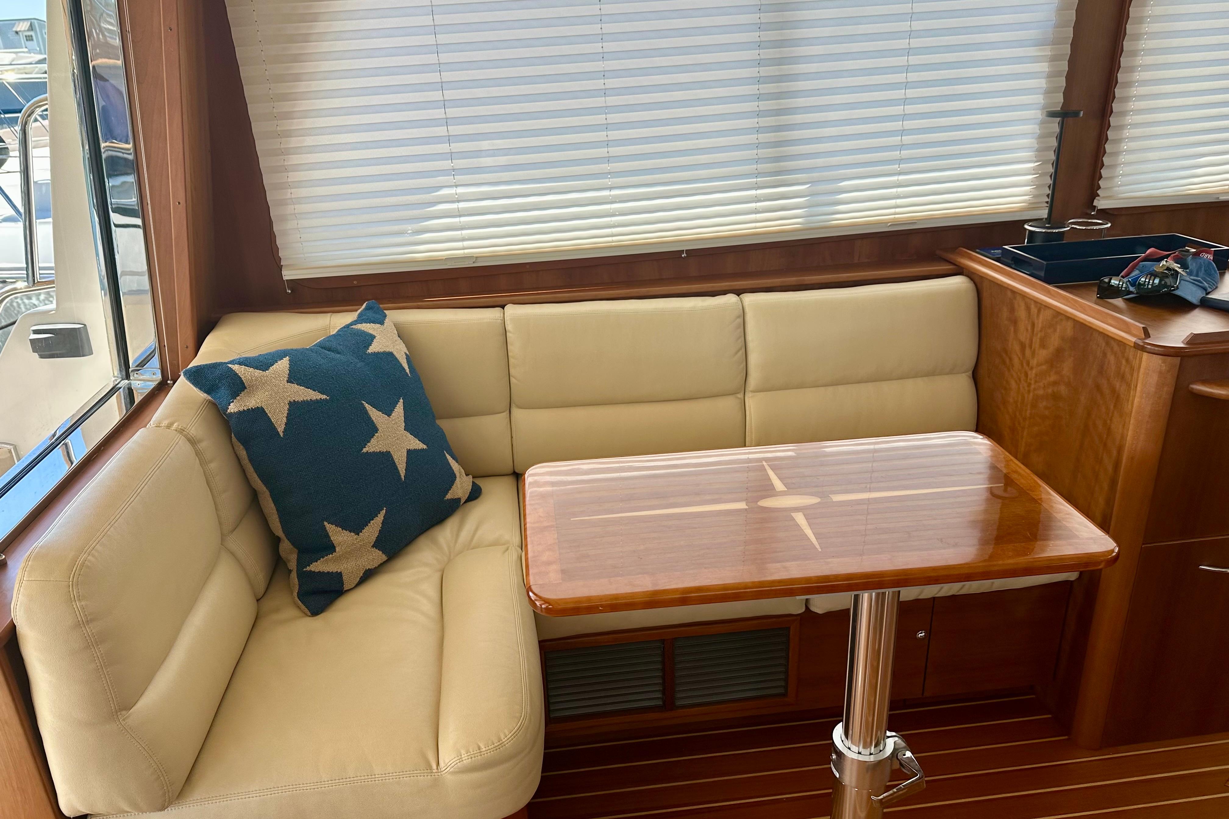 Interior of 2017 Sabre 42 Salon Express with beige seating and star-patterned pillow.