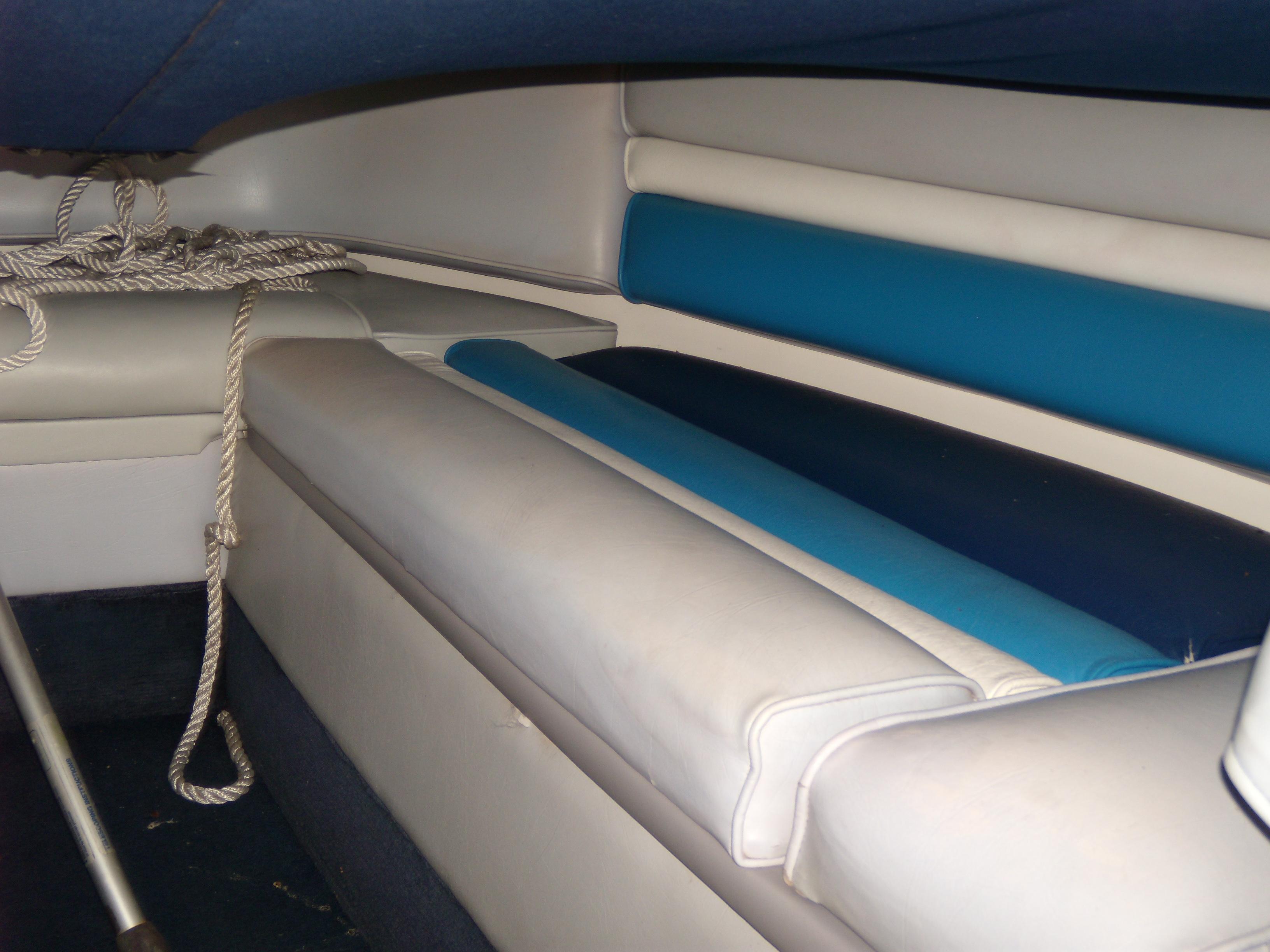 Interior of 1989 Chaparral 2300 SX Sport boat with blue and white seating.