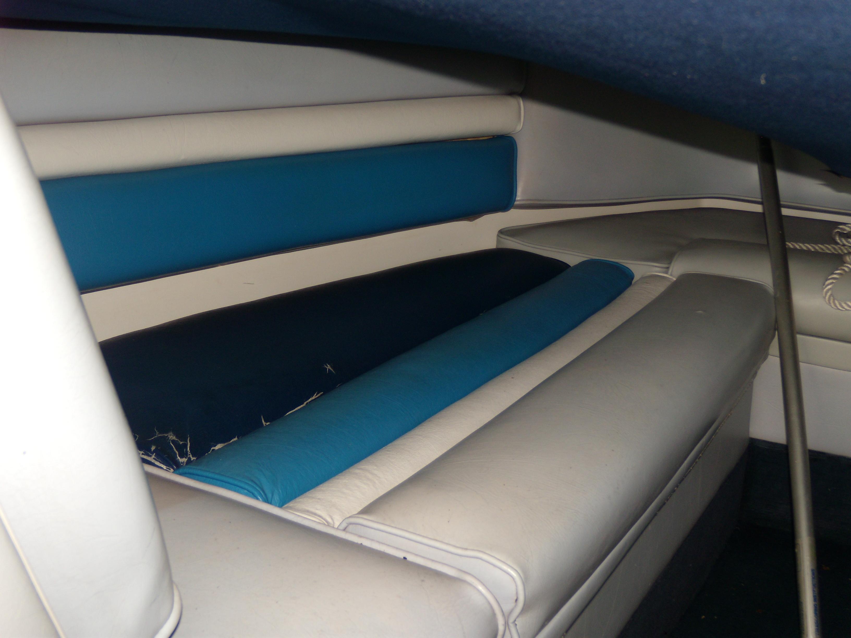 Interior seating of 1989 Chaparral 2300 SX Sport boat, featuring blue and white upholstery.