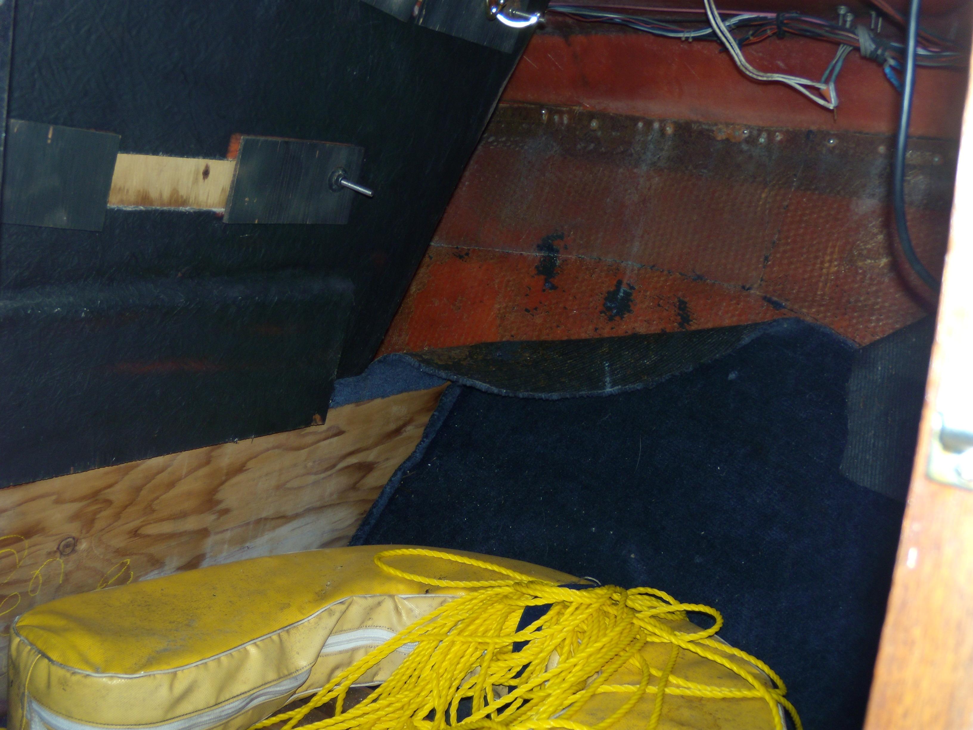 Interior of 1989 Chaparral 2300 SX Sport boat with yellow cushions and rope.