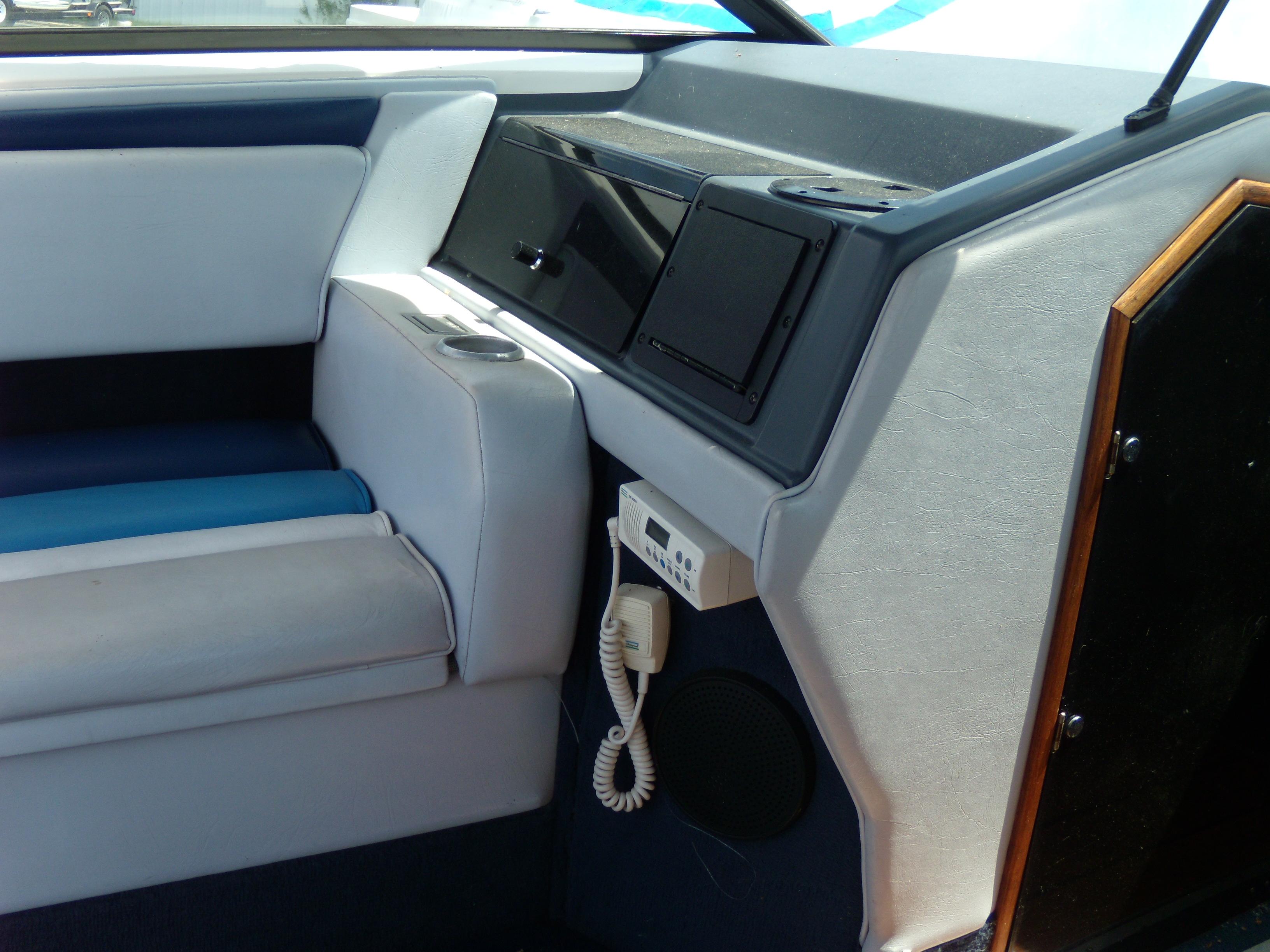 Interior of 1989 Chaparral 2300 SX Sport boat with seating and control panel.
