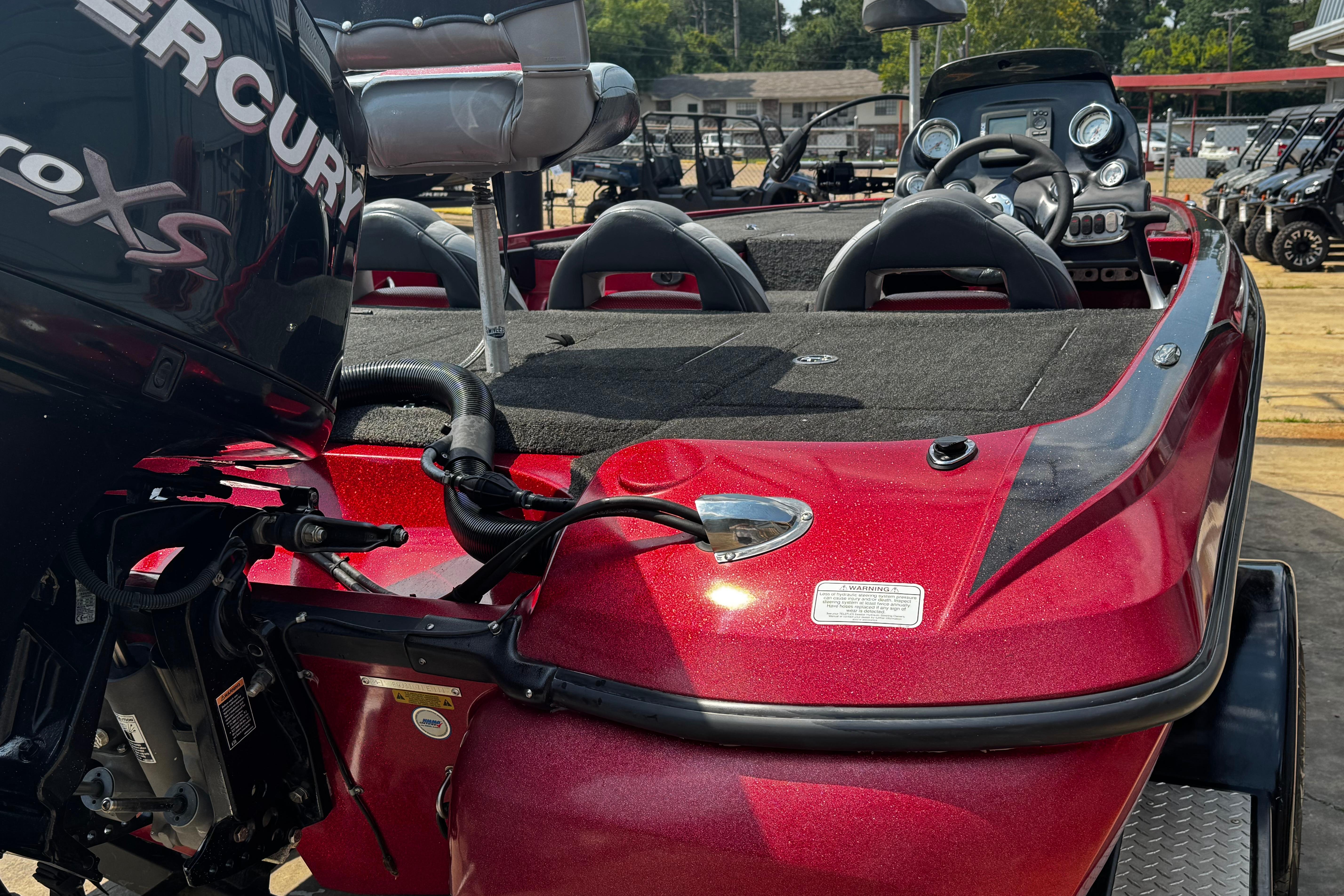 Red 2011 Nitro Z7 boat with Mercury engine, featuring dual seats and steering console.