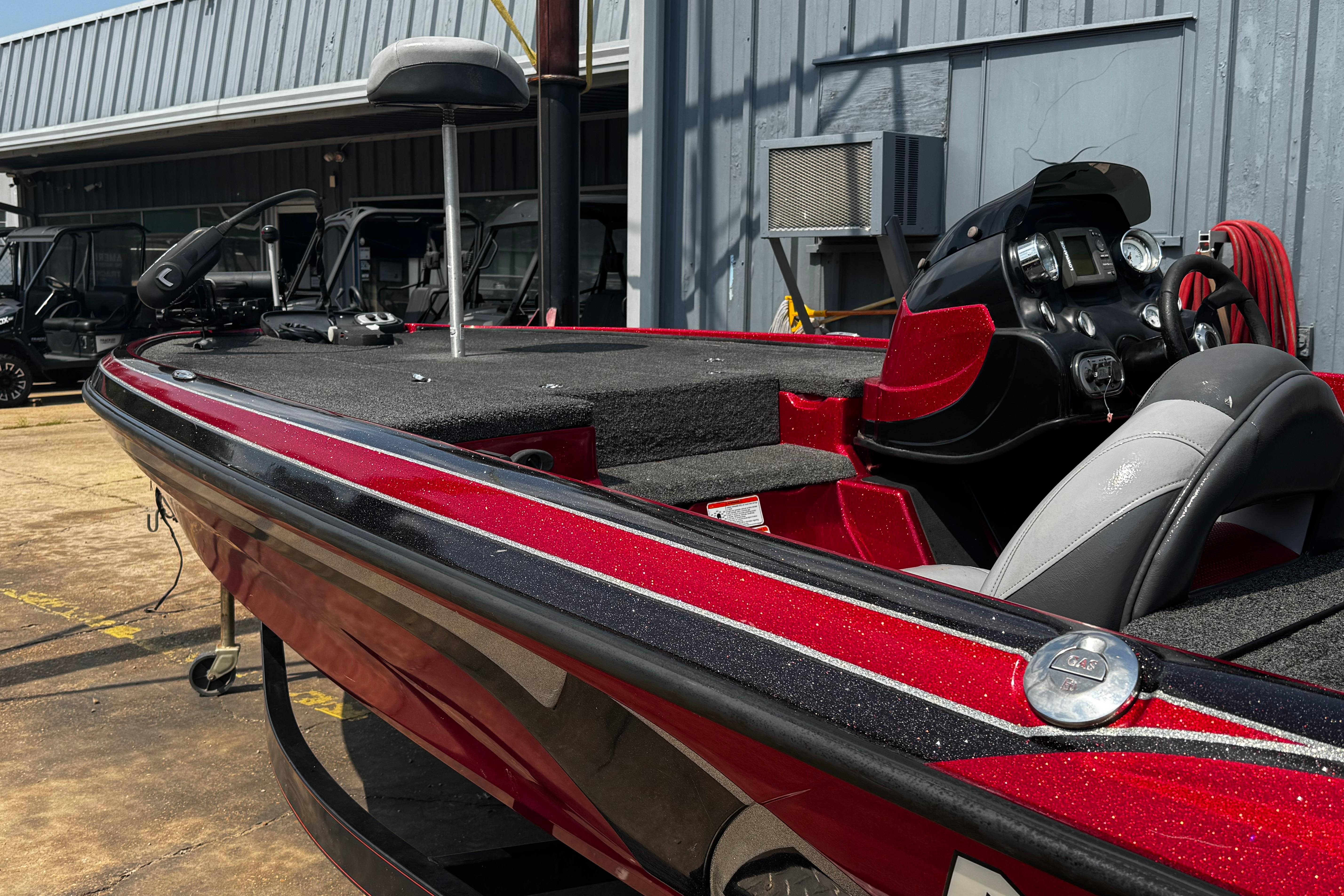 Red 2011 Nitro Z7 bass boat with sleek design and modern dashboard.