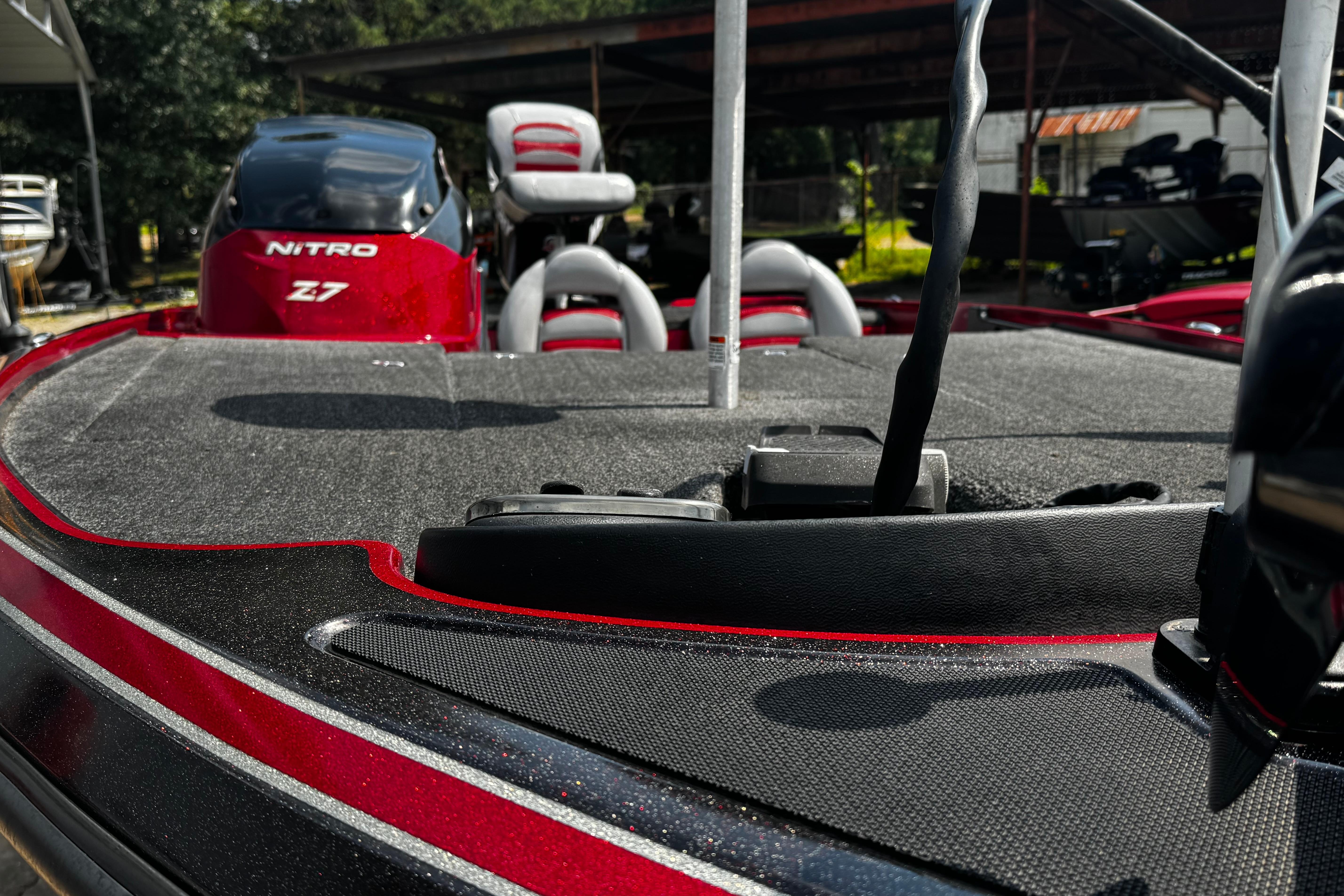 Red and black 2011 Nitro Z7 boat deck with seating and motor.