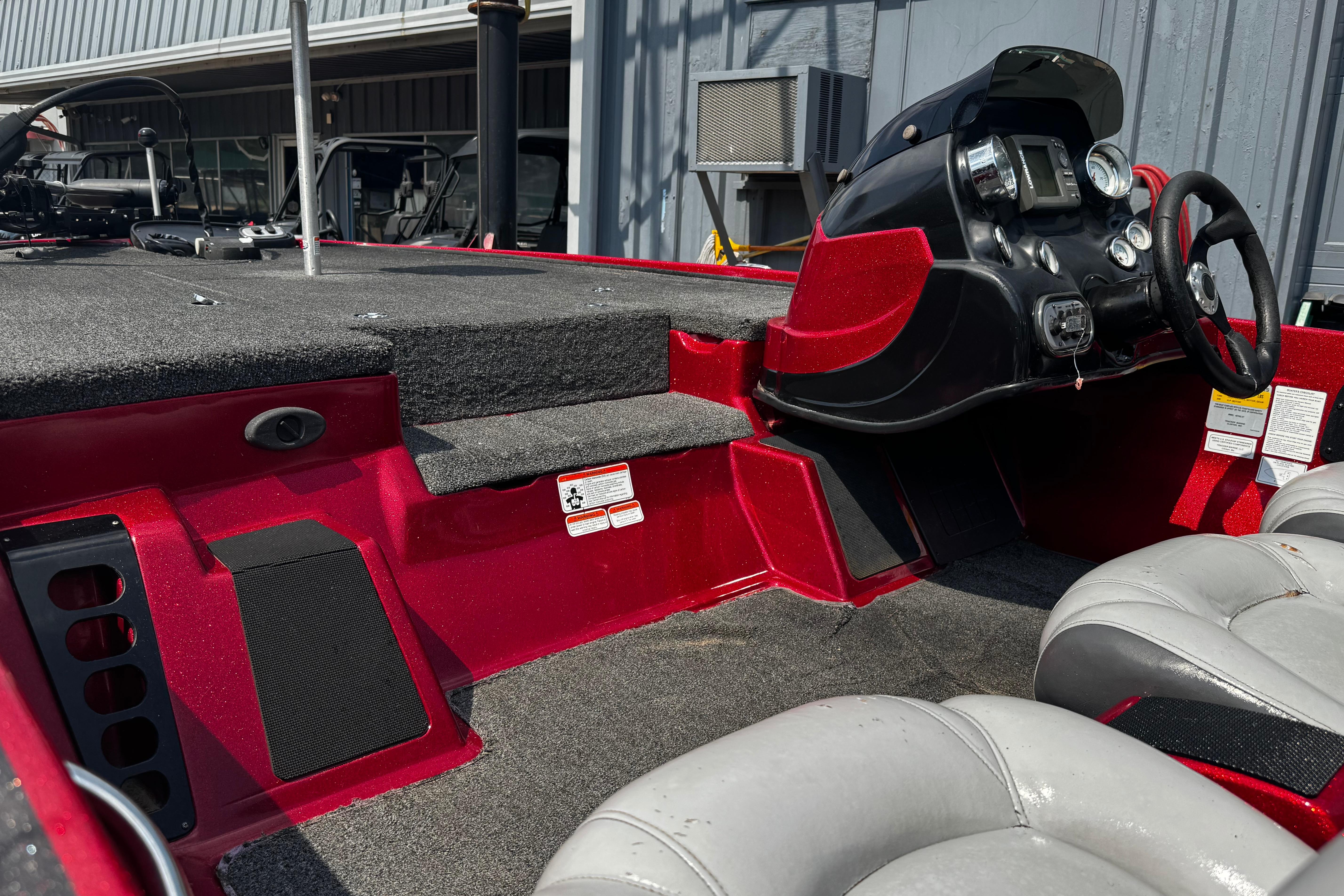 2011 Nitro Z7 boat interior with red and black dashboard, steering wheel, and seating.