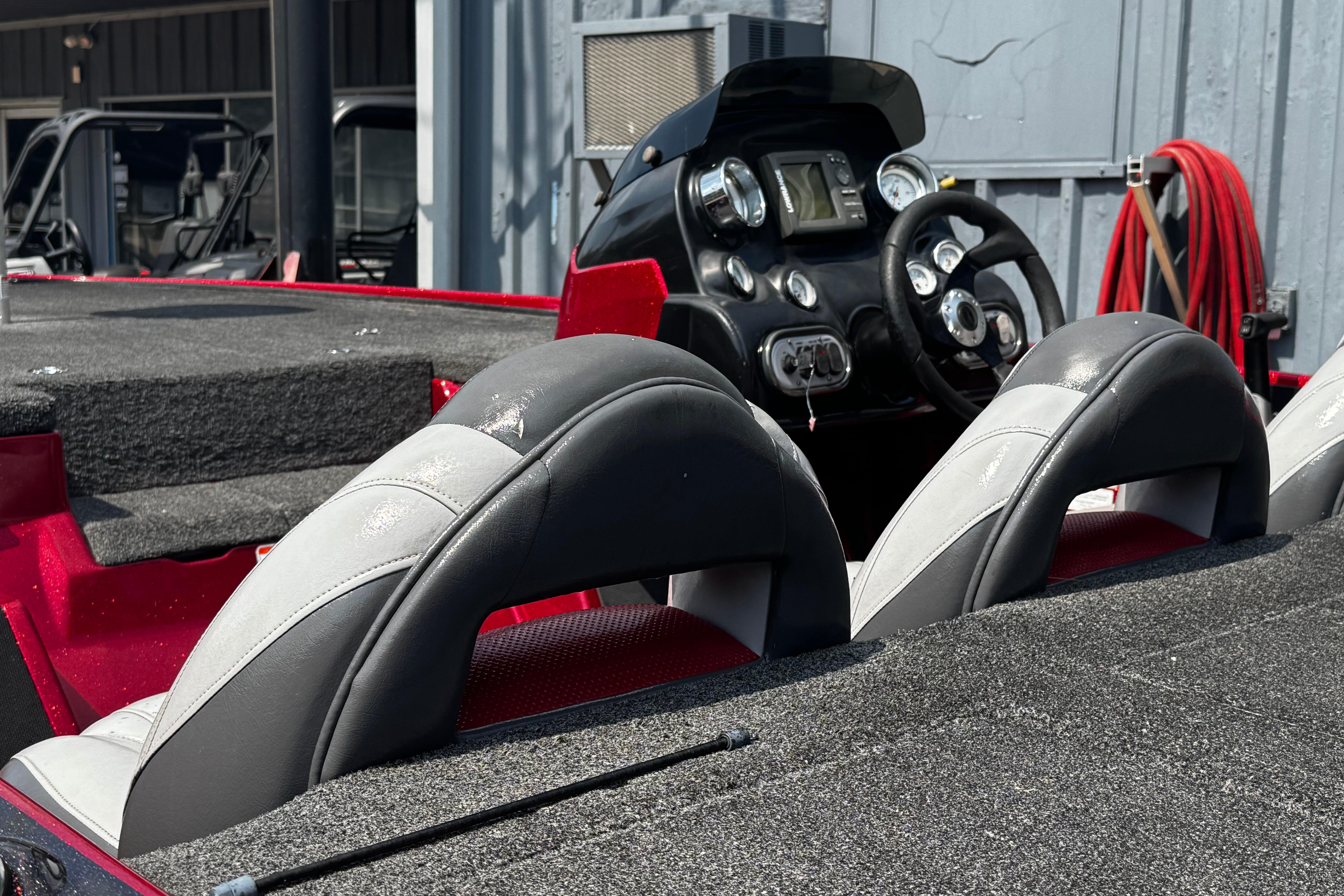 Interior of a 2011 Nitro Z7 boat with steering console and cushioned seats.