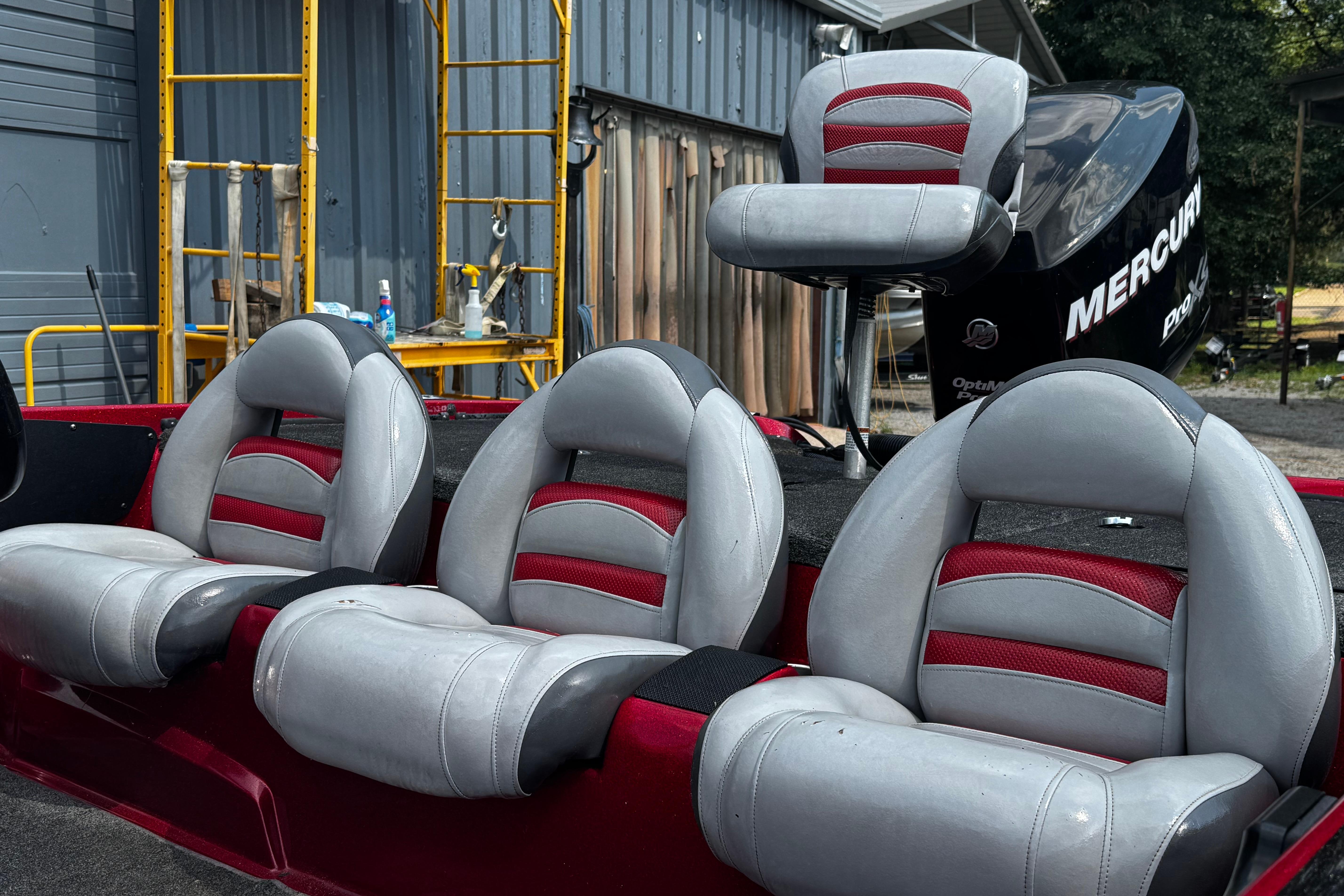 2011 Nitro Z7 boat with red and gray seats, Mercury engine in background.
