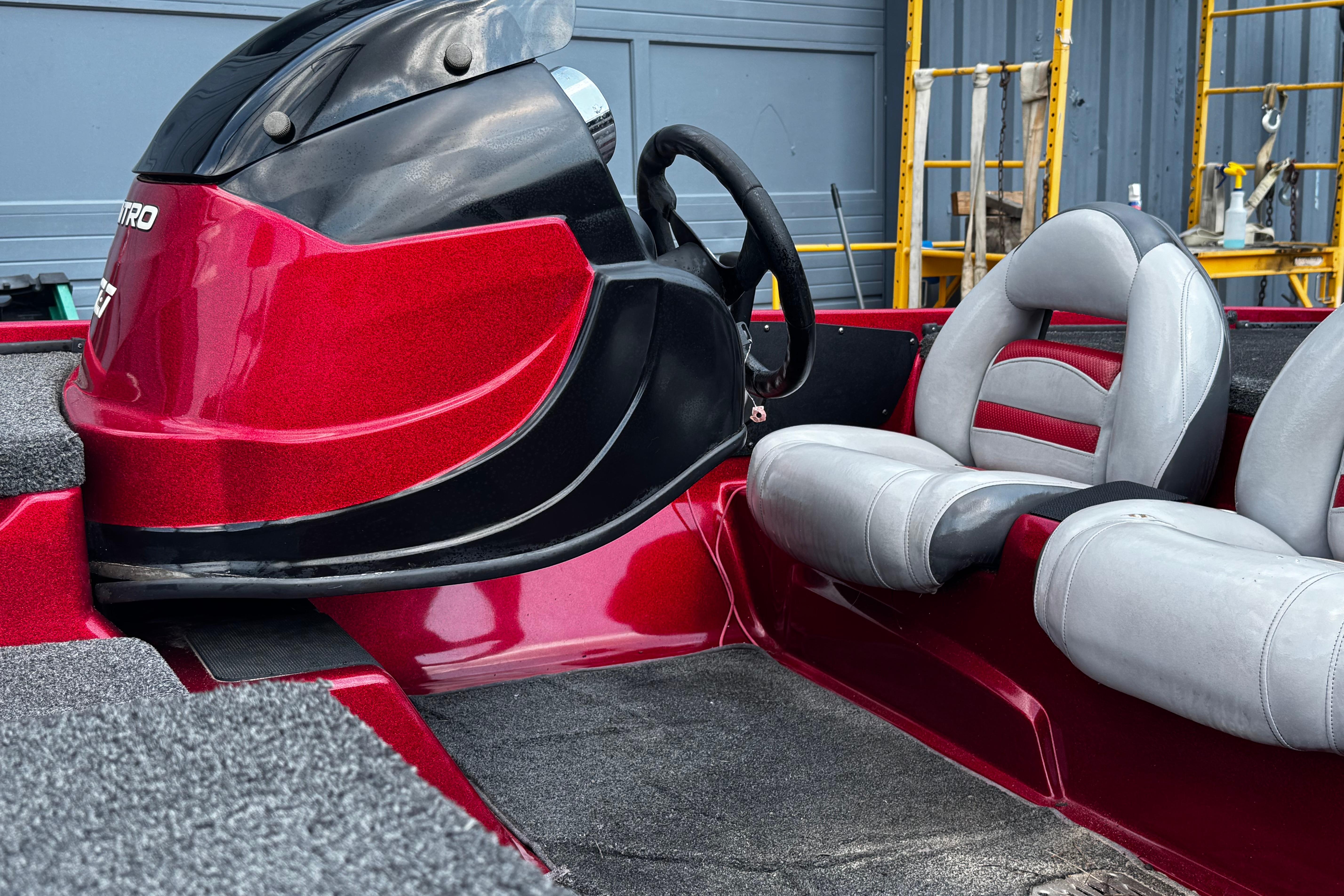 Red and black Nitro Z7 boat interior with gray seats, 2011 model.