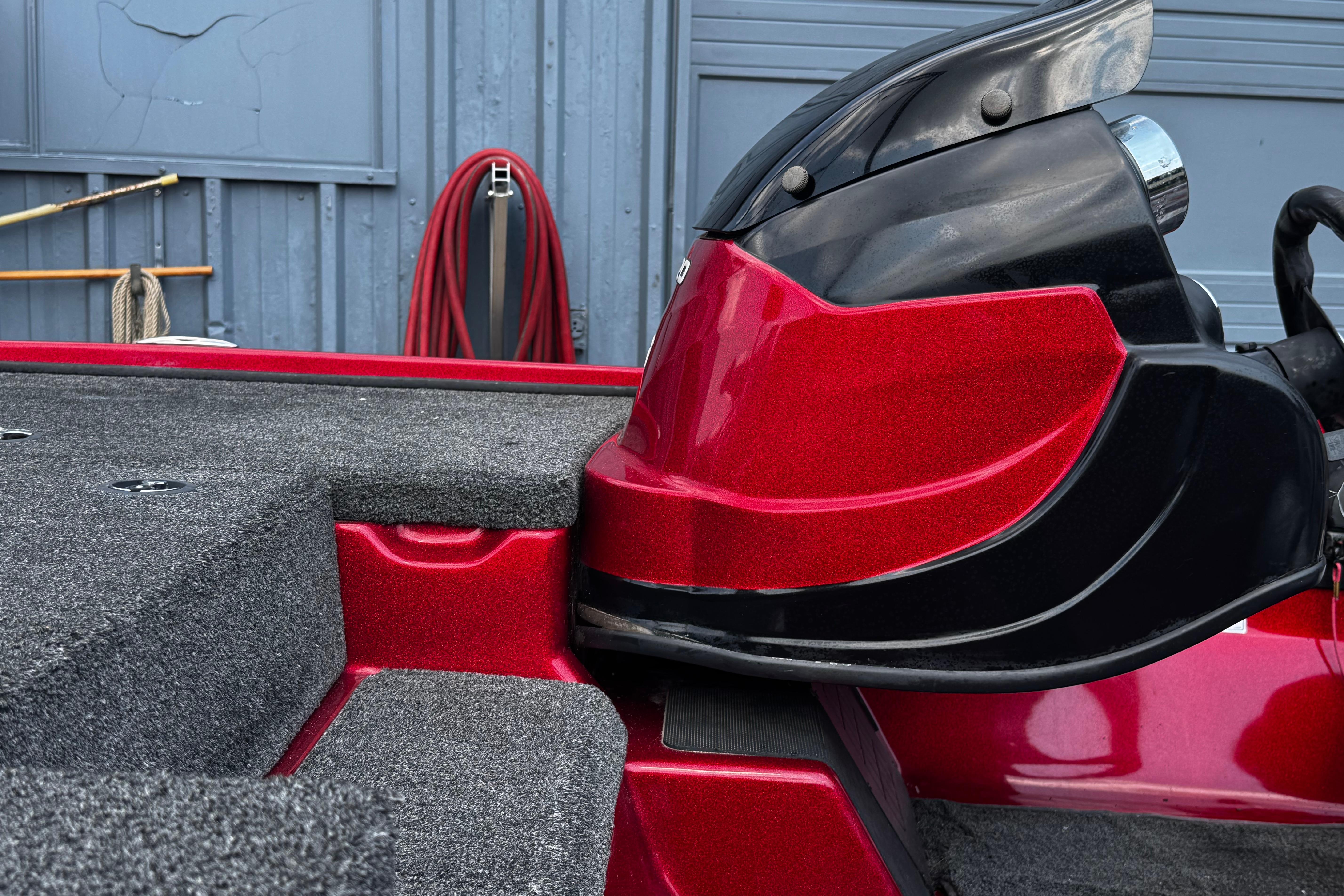 Red and black 2011 Nitro Z7 boat detail with textured flooring.