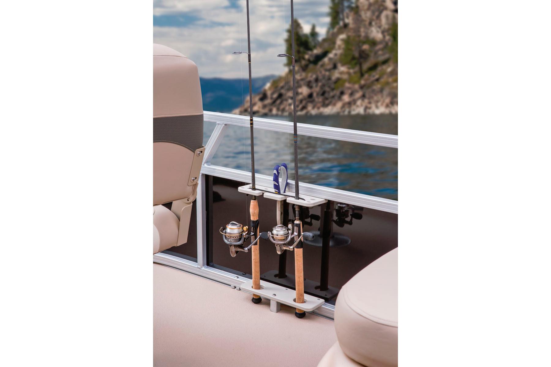 2014 Sun Tracker Bass Buggy 18 DLX with fishing rods on a serene lake.