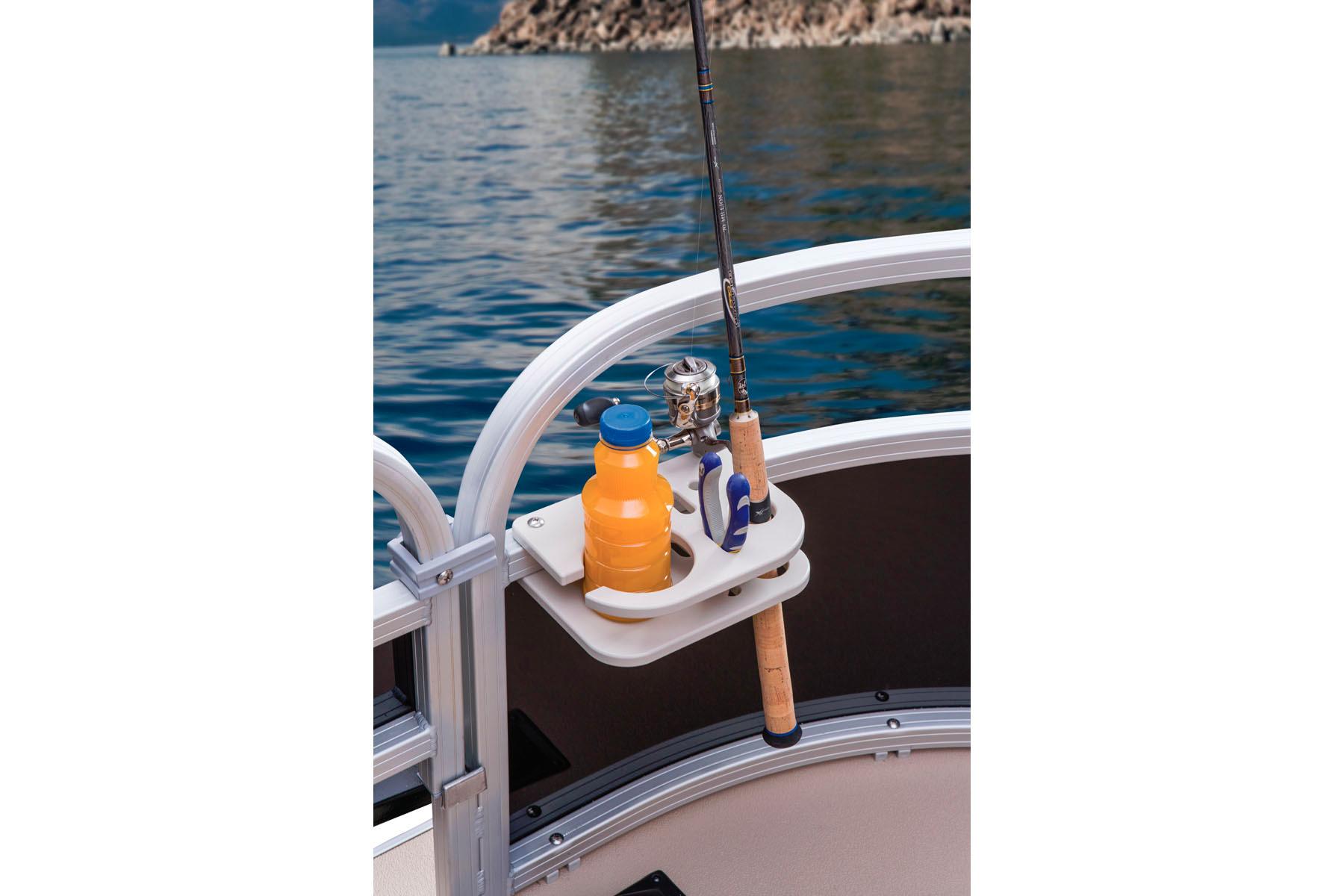 2014 Sun Tracker Bass Buggy 18 DLX with fishing rod and drink holder on a lake.