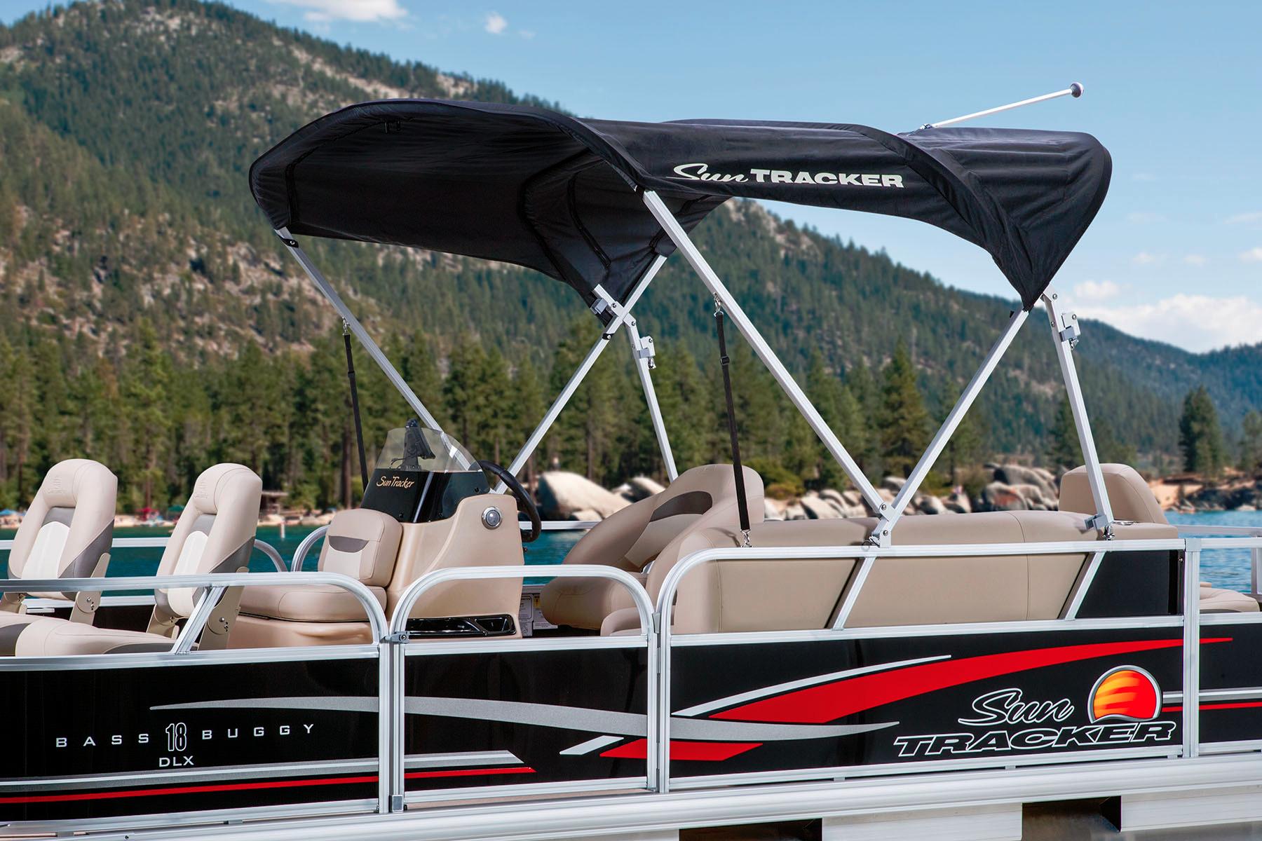 2014 Sun Tracker Bass Buggy 18 DLX pontoon boat on a scenic lake.