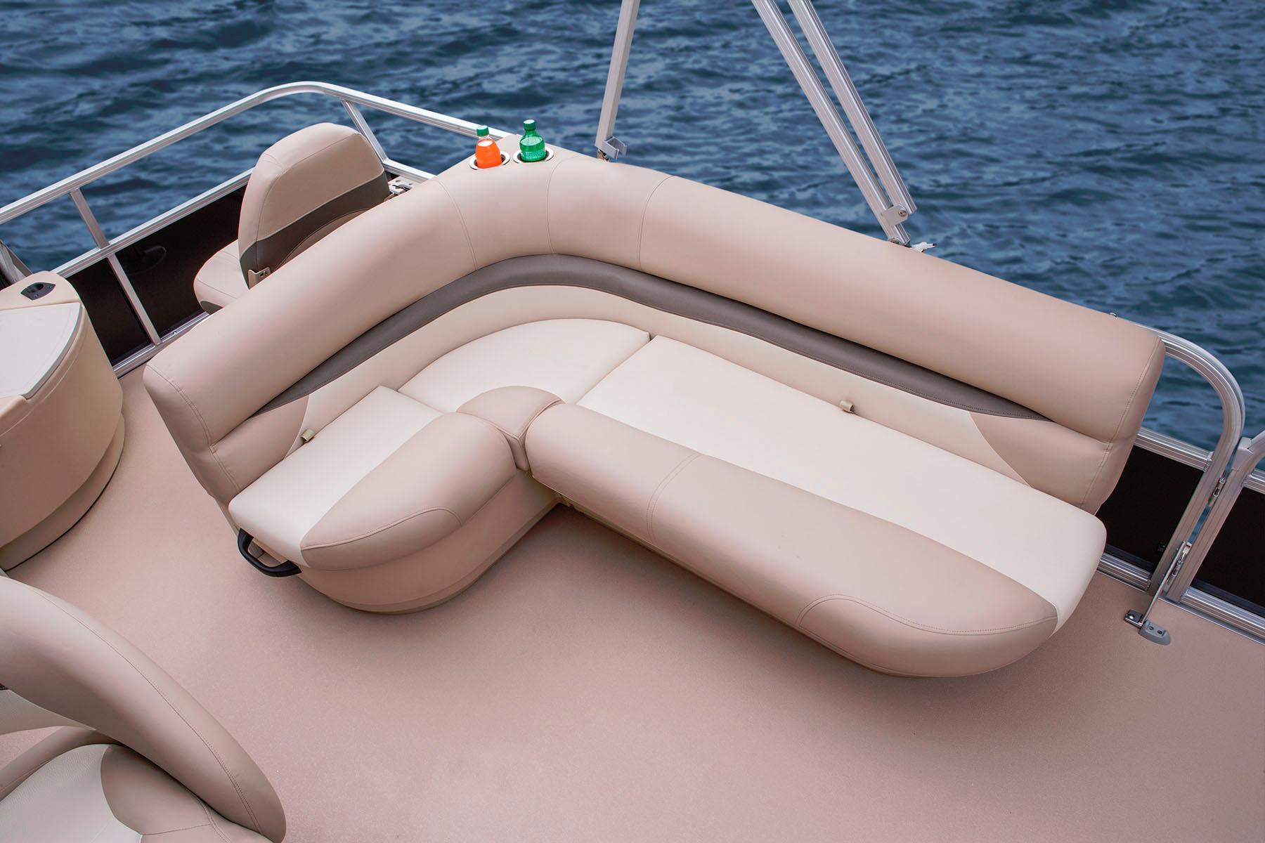 2014 Sun Tracker Bass Buggy 18 DLX pontoon boat with beige seating on water.