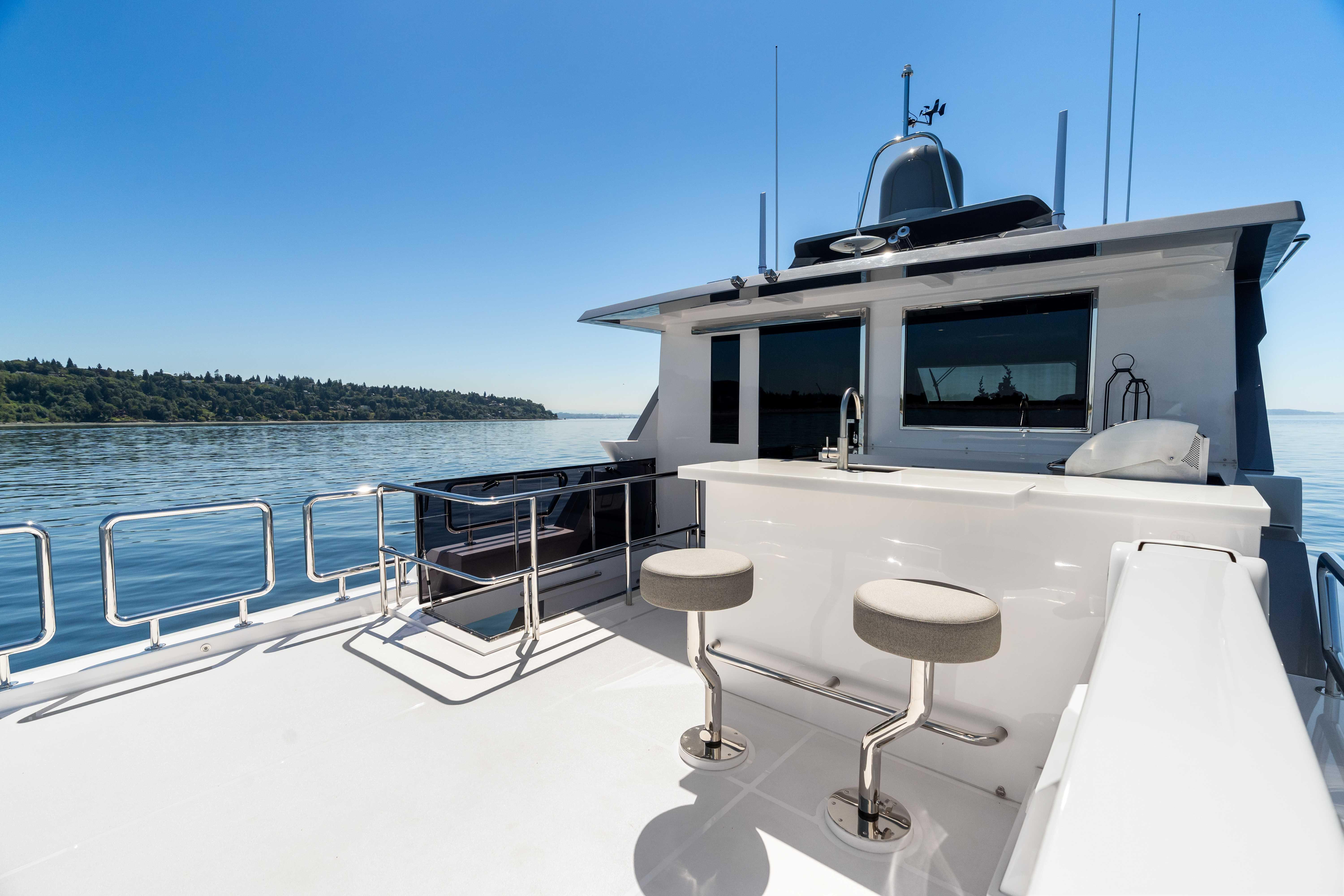 Horizon-V68 2025-V68-612 / NOW AVAILABLE FL-US-Luxury Horizon V68 yacht deck with bar stools, overlooking serene waters, 2025 model.-9631300 | Thumbnail