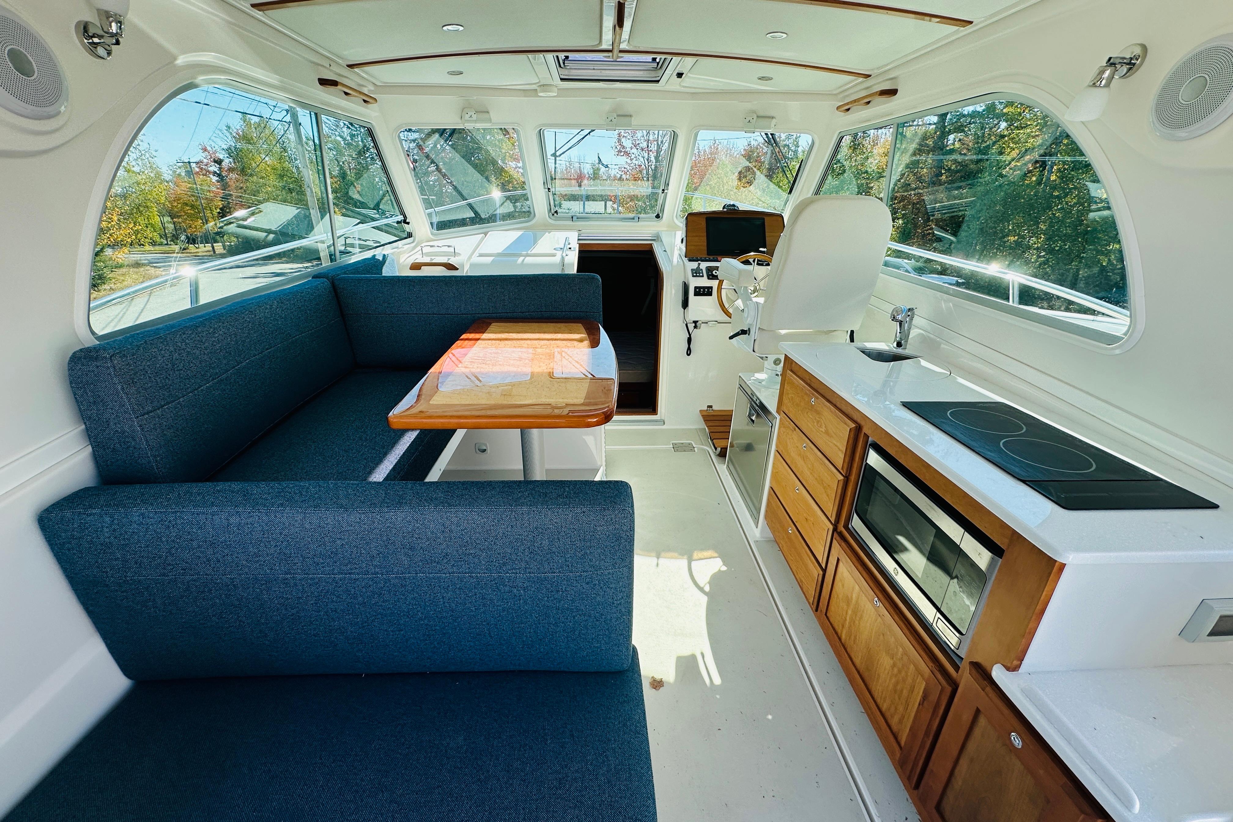 2024 Back Cove 34O interior with modern kitchen, seating, and helm station.
