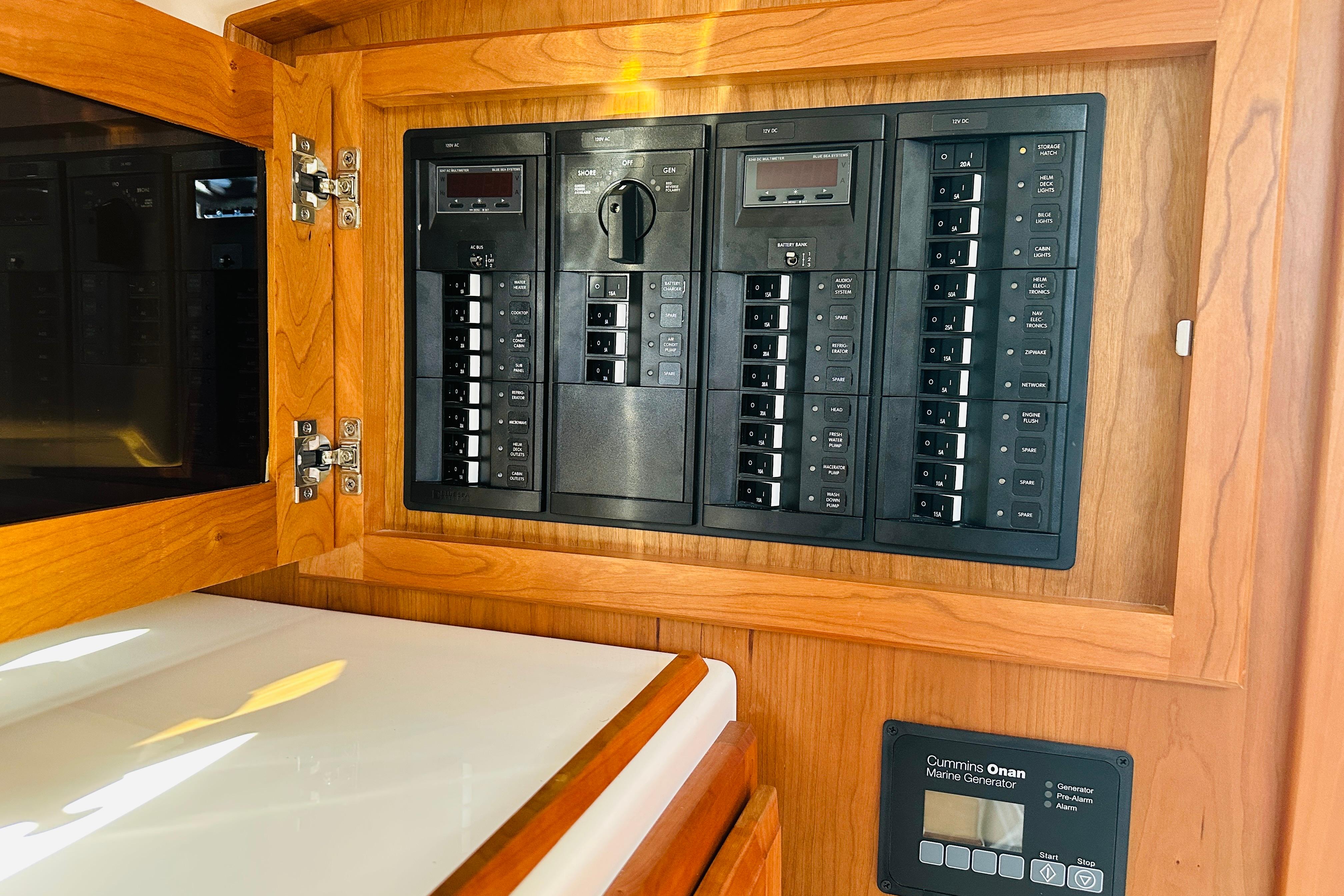 Electrical panel inside 2024 Back Cove 34O boat with Cummins Onan marine generator controls.