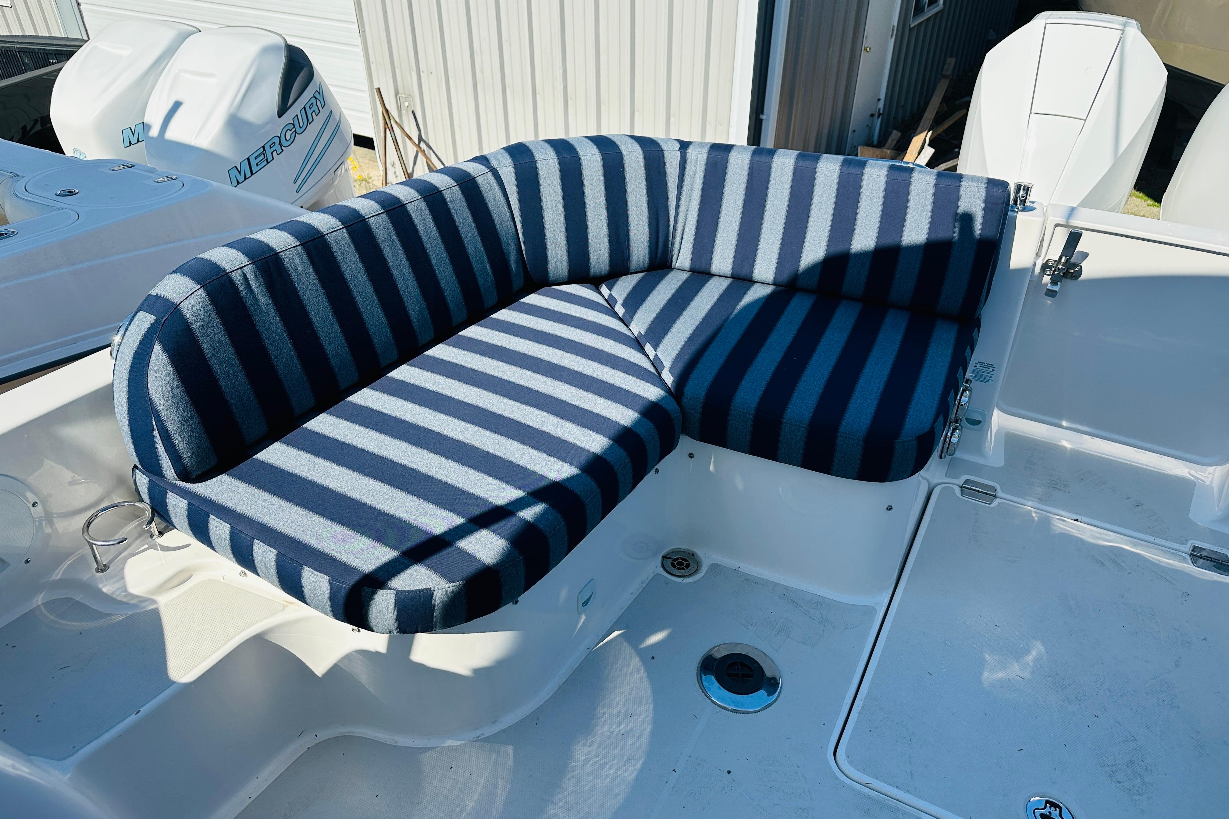 2024 Back Cove 34O boat with striped seating and Mercury outboard engines.