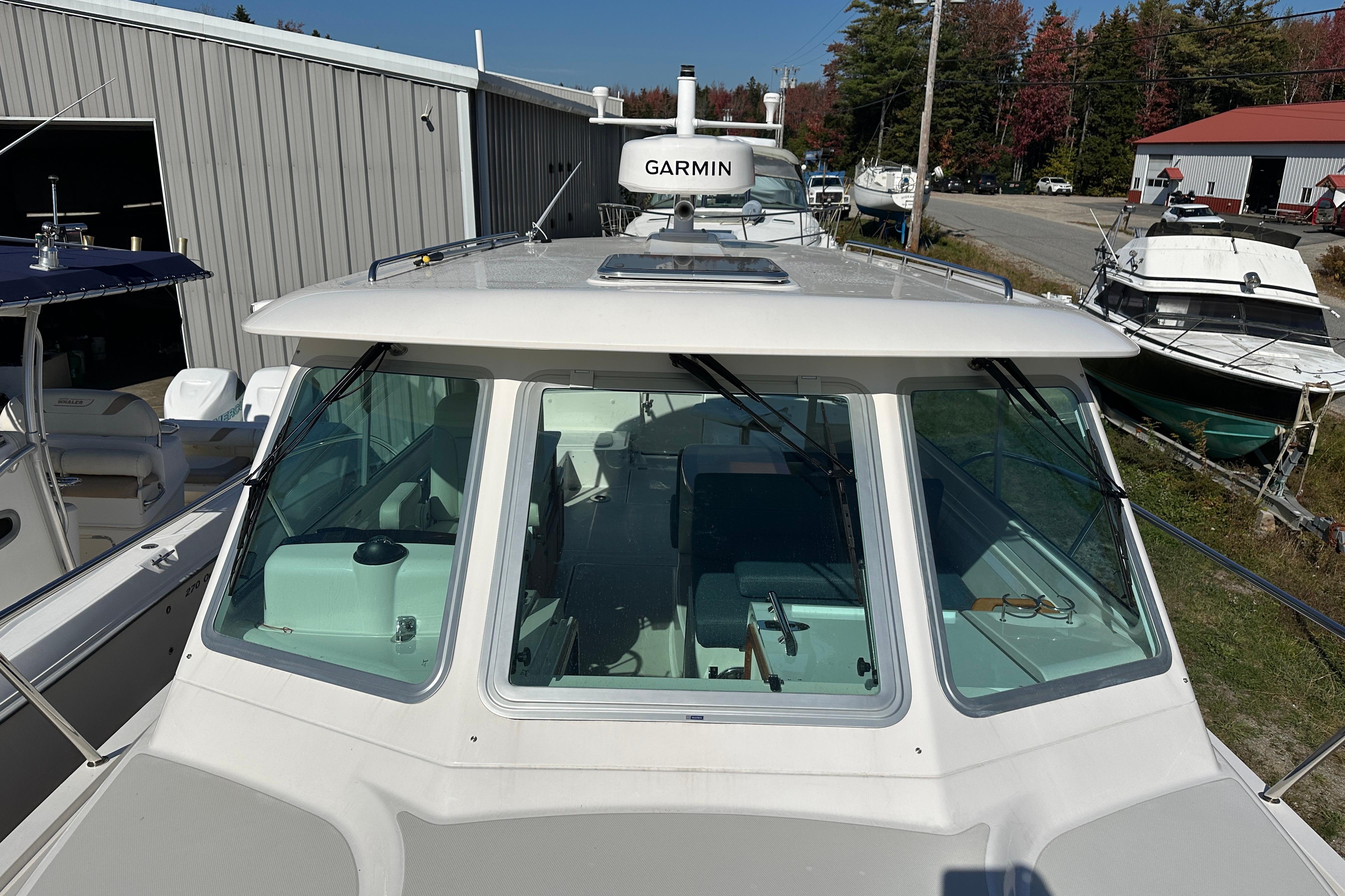2024 Back Cove 34O boat with Garmin equipment, docked near a storage facility.