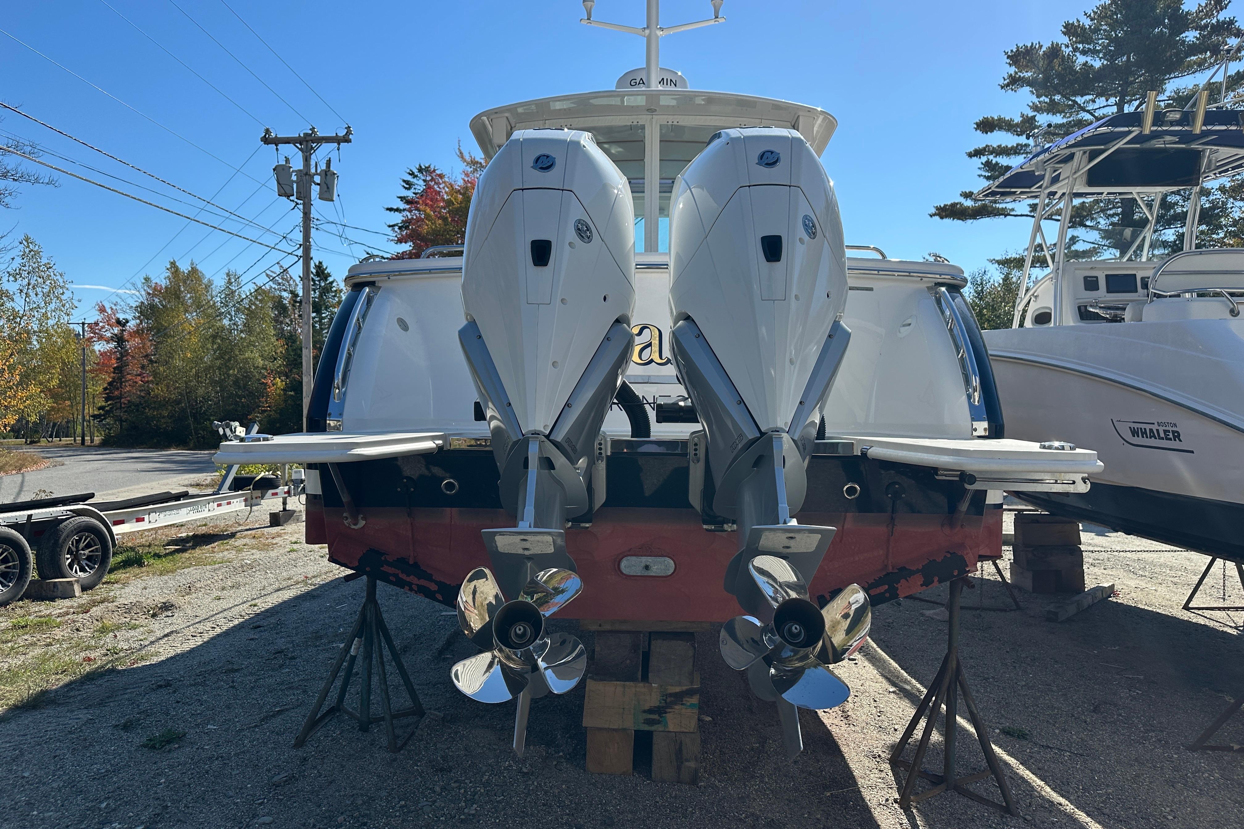 2024 Back Cove 34O boat with dual outboard engines on display outdoors.