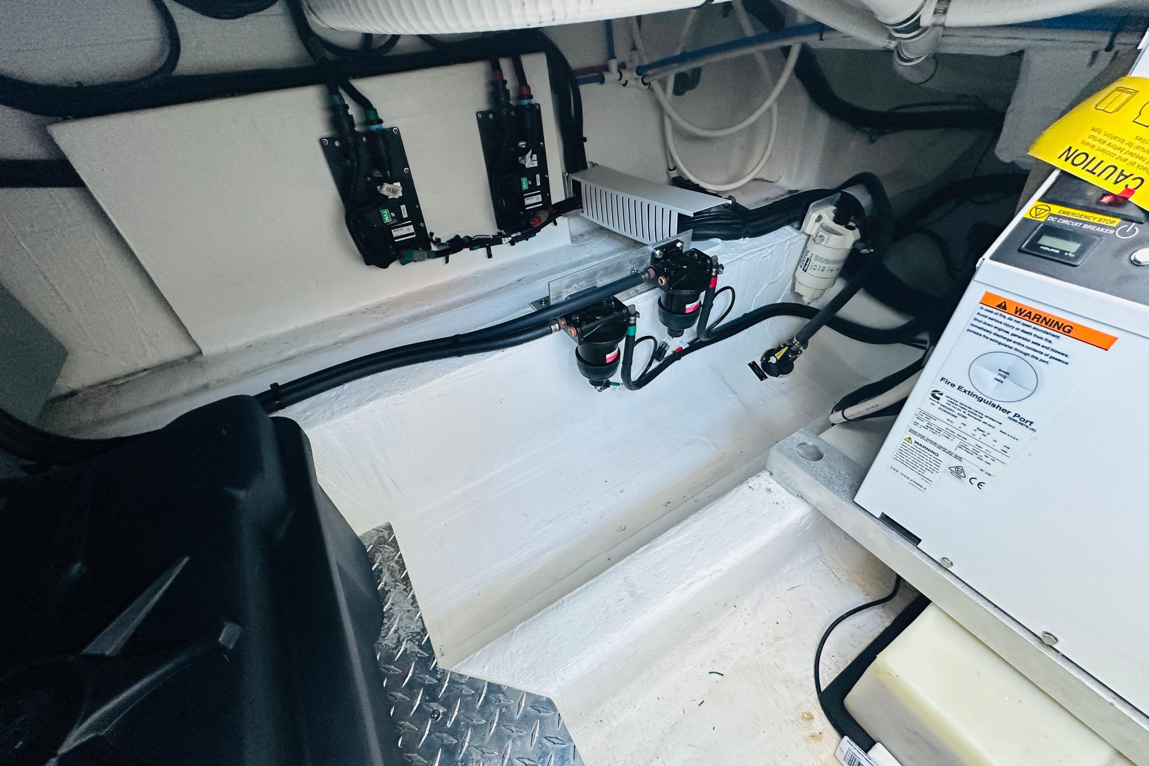 Engine compartment of 2024 Back Cove 34O boat, featuring wiring and safety equipment.
