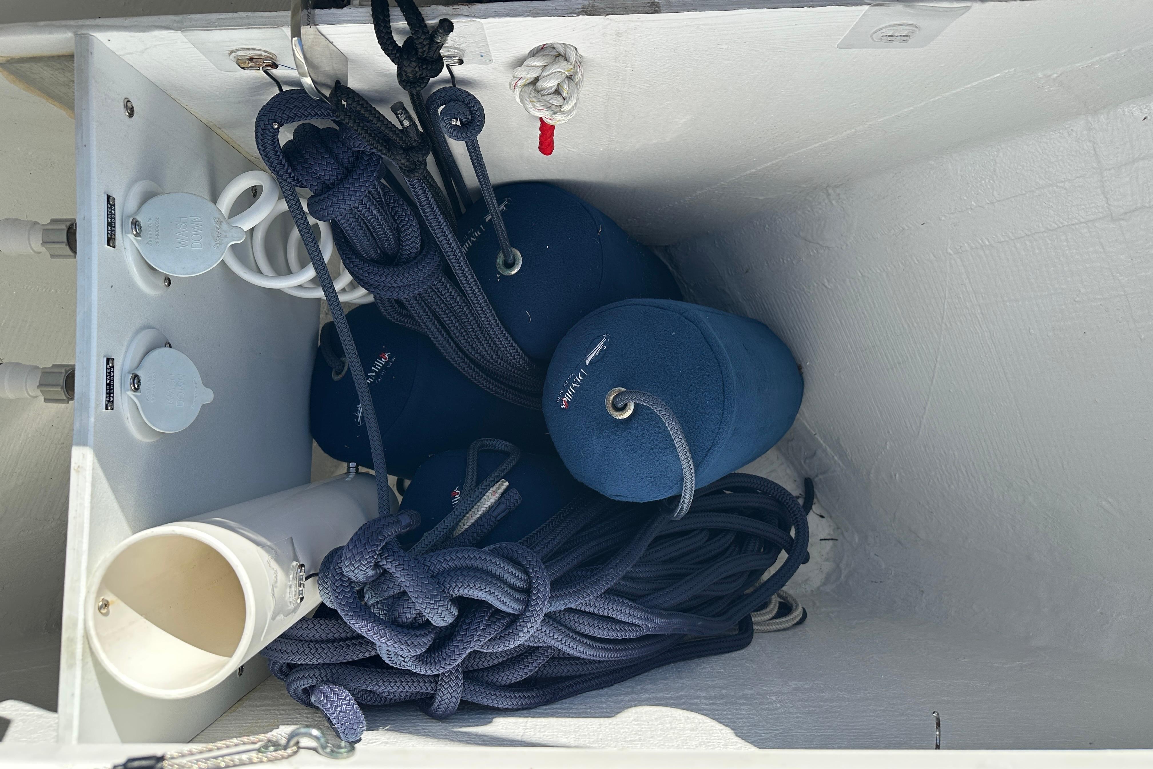 Storage compartment on 2024 Back Cove 34O boat with ropes and fenders.
