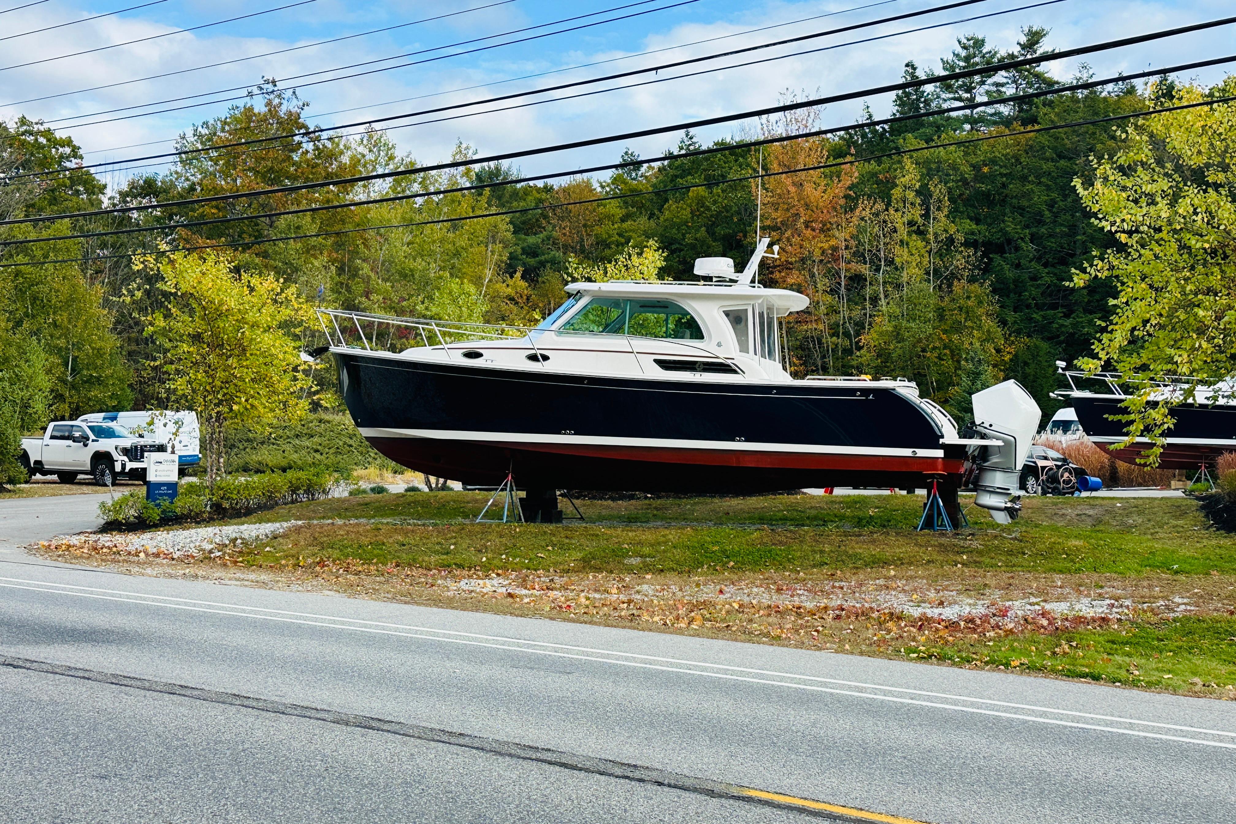 2024 Back Cove 34O boat displayed outdoors on a grassy area.