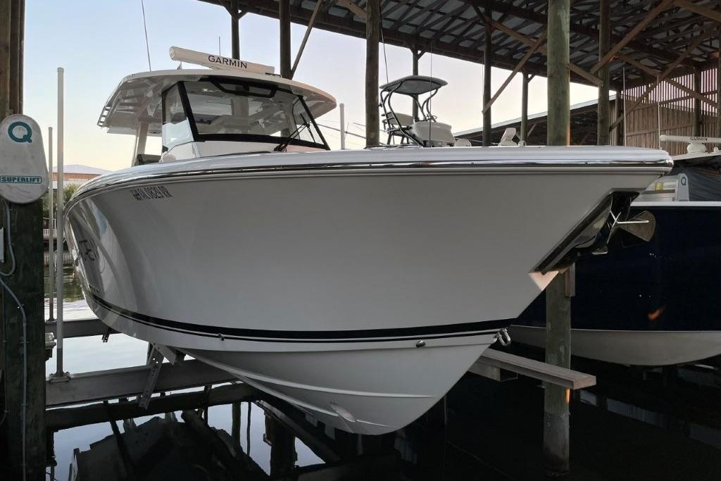 2023 Pursuit S 358 Sport boat docked in a marina.