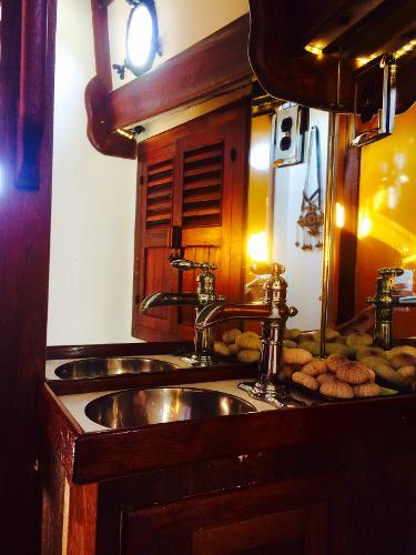 Vintage 1971 Formosa 41 yacht interior with wooden cabinetry and dual sinks.