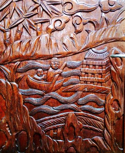 Intricate wooden carving depicting a boat scene with figures and a pagoda, Formosa 41, 1971.