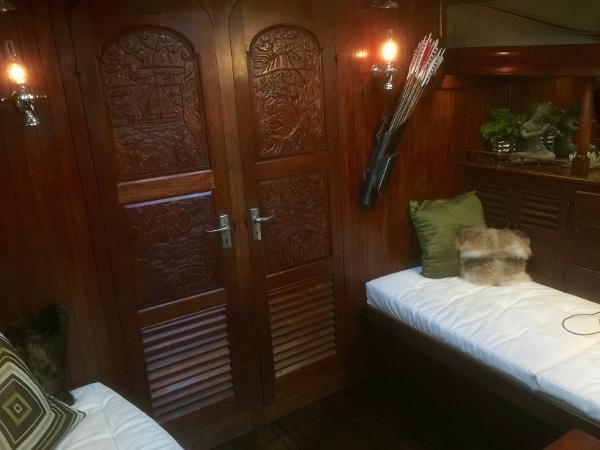 Interior of 1971 Formosa 41 yacht with carved wooden doors and cozy seating area.