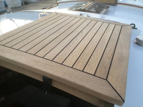 Wooden deck hatch on 1971 Formosa 41 sailboat, showcasing sleek craftsmanship and design.