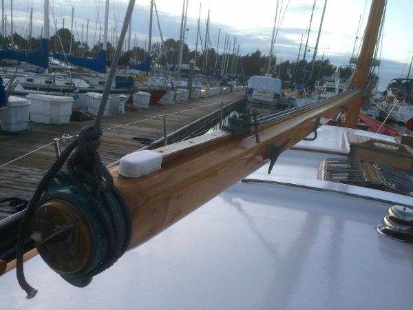 1971 Formosa 41 sailboat deck with wooden boom, docked in marina.