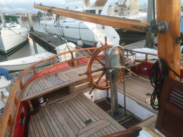 1971 Formosa 41 sailboat with wooden deck and steering wheel, docked at a marina.