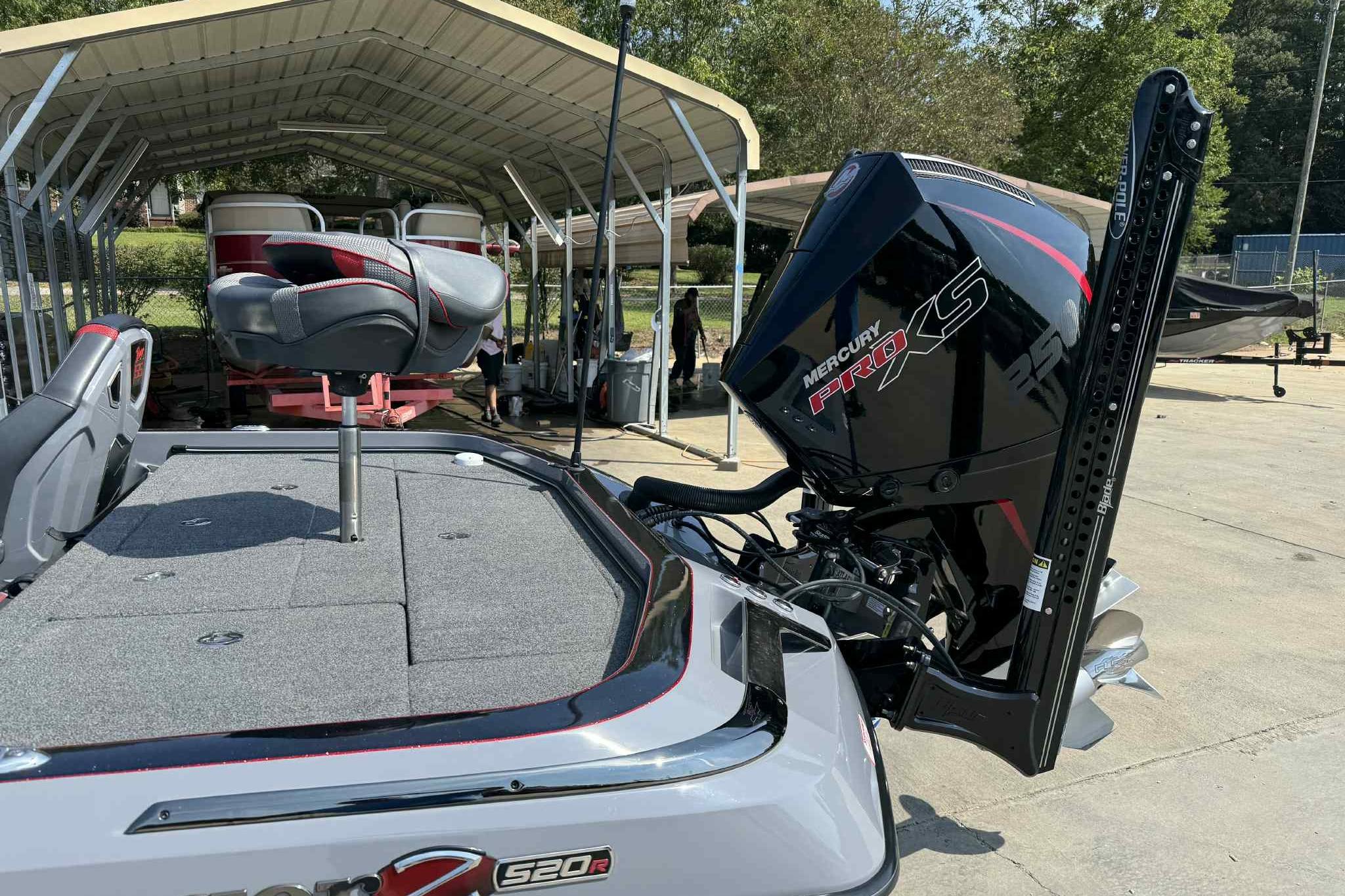 2023 Ranger Z520R 55th Anniversary boat with Mercury Pro XS engine, docked under a canopy.