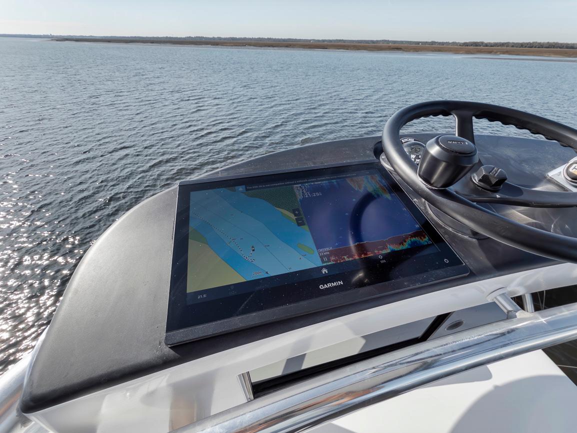 Garlington-44 Express 1996 -FL-US-Garlington 44 Express 1996 boat helm with Garmin navigation display on calm water.-9651424 | Thumbnail